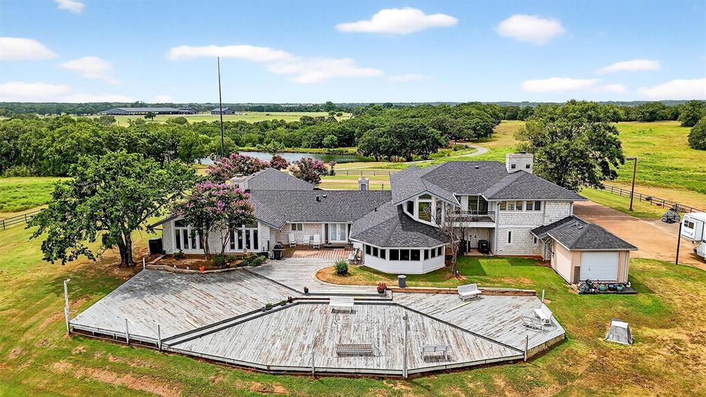 92± Private Acres on the Edge of Lake Texoma-- Ranch, Revenue-generating Retreat, or Redevelopment Opportunity. Adjacent to Rock Creek Resort luxury lake development and golf course! For the first time on the market in over 40 years, this incredible property offers endless possibilities. Framed by rolling hills and native oaks, it sits at Rock Creek & Liberty Rd, just minutes from Lake Texoma's shores and marinas. The land is fully pipe-fenced, backs to U.S. Army Corps of Engineers property for lasting privacy, and includes three water wells, two ponds, and an 80x40 shop with full kitchen and bath. At its heart is a custom 5,000± sq ft home with 5-car garage and a massive deck overlooking the pristine wilderness. New roof with cat 4 shingles! This is an EXPANSIVE property that sits in a high growth corridor. Private showings scheduled by texting listing agent or co-listing agent.