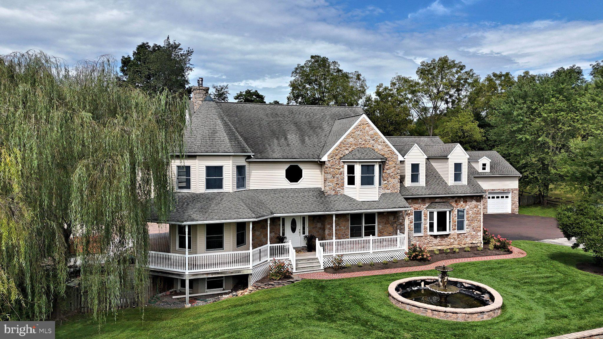 WELCOME HOME! Set on 2.86 acres in the desirable Spring City area and Owen J. Roberts School District, this impressive 4-bedroom, 3.5-bath home offers approximately 4,555 square feet of living space, exceptional privacy and incredible indoor and outdoor spaces designed for everyday living and entertaining! Built in 2001, this spacious two-story home welcomes you with charming wraparound porches and a generous floor plan featuring central air and four fireplaces that add warmth and character throughout. Four well-sized bedrooms provide comfortable private retreats, while 3 full bathrooms and a convenient powder room offer plenty of space for family and guests. The finished basement provides even more room to spread out, with ample space for a pool table, recreation area, home gym, media room or additional entertaining space. Step outside and discover your own private backyard oasis! The in-ground gunite pool is surrounded by expansive outdoor living areas perfect for relaxing and entertaining throughout the warmer months. Gather around the impressive stone patio featuring a stone fireplace and built-in outdoor grill, unwind in the hot tub, or relax beneath the gazebo while enjoying the peaceful surroundings. Beautiful water fountains and water gardens add to the tranquil setting and create a truly special outdoor retreat. With 2.86 acres, wraparound porches and multiple outdoor gathering spaces, this property offers an exceptional combination of space, privacy and entertainment possibilities. Enjoy the peaceful Chester County setting while remaining convenient to shopping, dining, recreation and the popular towns of Phoenixville, Exton and Downingtown. Offering an incredible combination of generous living space, acreage, privacy, a finished basement, resort-style outdoor amenities and a convenient location, 2 Traber Lane is a home you won't want to miss. Make your appointment today!