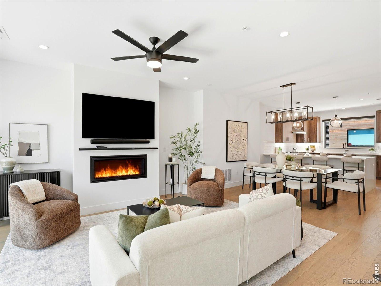 Location, luxury, and lock-and-leave convenience converge in this impeccably maintained Walnut Crossing townhome. Built in 2022 with sophisticated modern design and premium finishes throughout, the light-filled open floor plan showcases floor-to-ceiling windows, rich hardwood flooring, a sleek gas fireplace, and seamless indoor-outdoor living with private outdoor spaces on every level. Easy, low-maintenance living makes it an exceptional primary residence, sophisticated second home, or investment property. Rare among central Boulder's HOA communities, Walnut Crossing permits short-term rentals, offering flexibility and income potential in one of the city's most sought-after locations. Set along the quieter Walnut Street side of the development, it offers both tranquility and unrivaled convenience, near Pearl Street, CU Boulder, shopping, fitness studios and Sundance Film Festival venues. The chef's kitchen features Viking appliances, custom cabinetry, and high-end fixtures, perfect for entertaining. The primary suite offers a spa-inspired bath and refined finishes. The expansive rooftop deck delivers breathtaking views of the Flatirons and downtown Boulder, outfitted with a water and gas line ready for a fire pit and outdoor kitchen-an extraordinary setting to entertain or unwind under Colorado's iconic skies. Additional highlights include two covered parking spaces, EV charging, private storage, an ADT security system with cameras, and upgraded electronic keypad locks and motorized custom window shades throughout.This townhome has it all: modern luxury, incredible views, flexibility, everyday convenience, great flow, outdoor spaces and a perfect central Boulder location!