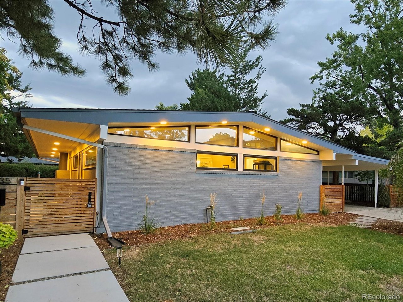 Looking for your new home near great parks, trails, schools, restaurants and retail? This south-facing 4BR 3BA home showcases the clean lines, vaulted ceilings and expansive windows that define classic mid-century design while being thoughtfully reimagined with modern updates. The kitchen features sleek countertops, custom cabinetry, designer tile, open shelving, stainless steel appliances and a spacious dining area perfect for everyday living and entertaining. Clerestory windows and walls of glass flood the home with natural light, creating a bright and open atmosphere that seamlessly connects indoor and outdoor living; custom window treatments complement the home's style while allowing coverage when you want it. The open-concept main level flows effortlessly to the spacious living areas and out through glass doors to a custom backyard retreat. Fully fenced and landscaped, the private outdoor living space includes an architectural pergola, gardens and multiple areas for dining, gathering and relaxing. A large shed in the breezeway offers expansive storage; the carport and driveway provide abundant off-street parking. The finished basement provides exceptional flexibility with a huge family room, two secondary bedrooms, a stylish 3/4 bath, and a bonus room ideal for a home office, gym, playroom or storage. Whether it's game day or movie night, a dedicated work-from-home setup, or accommodating multigenerational living, the lower level offers endless possibilities. Tucked into a quiet street in Denver's Observatory Park neighborhood near sought-after schools, restaurants, retail and the University of Denver, this home offers the best of both convenience and lifestyle. An incredible trail system is just a few houses away and a huge nearby park awaits, plus there's easy access to downtown Denver, Cherry Creek and quick routes west - or stay close and explore University Hills, Platt Park and Wellshire. Architecturally significant, beautifully updated and move-in ready!