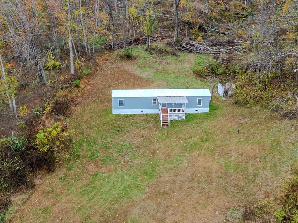 This home would make a perfect private retreat to the mountains! Its acreage combined with it's well maintained home  would be great for hunters, or for folks looking to live away from the traffic! While being tucked away in the mountains, it is also easily accessible from the interstate. The home features tile in the kitchen and bathroom, a cozy front porch, and a back deck ready for relaxing!