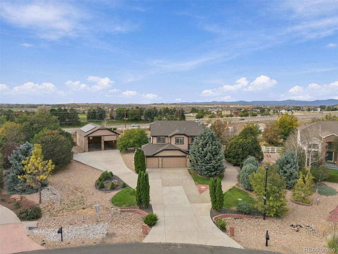 If you have toys, trailers, hobbies or simply dream of having room to spread out, this Todd Creek property delivers the kind of space that is increasingly hard to find. Don't miss the SELLER OWNED solar (Originally a $40k investment) which will also reduce your monthly expenses. Situated on 1.4 acres, this home offers an incredible combination of comfortable living, expansive outdoor space and exceptional storage. One of the true highlights is the enormous detached shop and garage, offering room for 4+ vehicles and an RV, plus valuable lofted storage that keeps gear organized without sacrificing workspace below. Whether you need space for a workshop, car collection, motorcycles, outdoor equipment or weekend projects, the possibilities are impressive. A separate gated parking area provides even more room to securely store trailers, pop up campers, jet skis, motorcycles and recreational toys right on your own property. Add the attached 3 car garage, large storage shed and generous acreage and there is truly a place for everything. Inside, hardwood flooring leads through spacious living areas and into a welcoming kitchen with extensive cabinetry, an oversized island and breakfast nook opening to the great room with gas fireplace. A flexible main floor room makes an ideal office, sitting room or den. Upstairs, the spacious primary suite features its own private sitting area, walk in closet and 5 piece bath, while generously sized secondary bedrooms include a Junior Suite with a private ensuite bath. The finished basement adds another large living area ready for movie nights, games, a home gym or entertaining. Outside, mature trees, hardscape walkways, covered patios, garden space and mountain views create a peaceful setting with room to enjoy the Colorado lifestyle. With quick access to E470 and I25, you can have acreage, storage and breathing room without giving up convenient access to shopping, dining and the city.