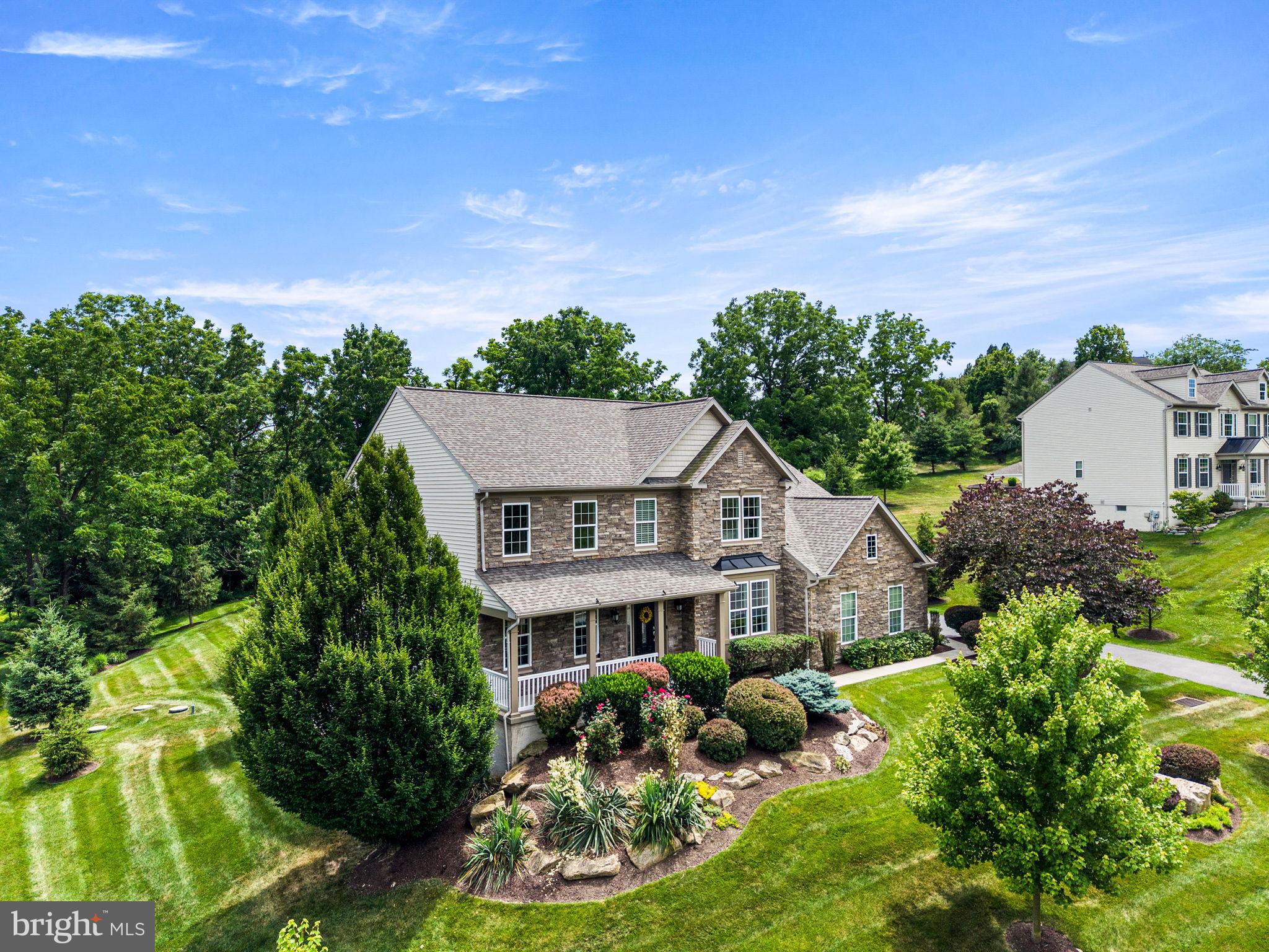 Welcome to this beautifully maintained Richmond American custom home offering 4 bedrooms, 3.5 bathrooms, and an exceptional combination of luxury, comfort, and modern upgrades. With fresh interior and exterior paint, extensive landscaping, and numerous recent improvements, this truly move-in-ready home has been meticulously cared for.The striking stone front elevation wraps around to the newly upgraded stone garage façade, creating impressive curb appeal. Professionally designed landscaping featuring more than 28 mature trees, flowering shrubs, a split-rail fence, and custom low-voltage landscape lighting with 256 programmable color options creates a private, park-like setting that is just as stunning after sunset as it is during the day. Outdoor living is exceptional with a spacious Trex deck, covered and screened porch with an outdoor Hunter ceiling fan, custom paver walkway, and a whole-home 22kW Generac generator for peace of mind year-round.Inside, the home has been freshly painted throughout, including closets, and features beautiful cherry hardwood floors, new carpeting, Hunter Douglas Silhouette window treatments, and elegant architectural details including coffered ceilings and a dramatic split staircase overlooking the foyer. The large family room showcases a floor-to-ceiling stone gas fireplace, soaring ceilings, and abundant natural light.The gourmet kitchen is designed for both everyday living and entertaining, featuring an oversized granite island, extensive granite countertops, abundant custom cherry cabinetry, KitchenAid appliances, dual ovens, and beautiful tile flooring that continues through the kitchen, sunroom, mudroom, and laundry room. The kitchen flows seamlessly into the sunroom, creating an ideal space for large family gatherings, with easy access to the Trex deck and screened porch.The first floor also offers a spacious dining room, living room, sunroom, mudroom, laundry room, and an upgraded powder room. Oversized doors and quality finishes throughout enhance the home's elegant feel.Upstairs, a separate HVAC system provides independent comfort for the bedroom level. The luxurious primary suite features its own gas fireplace, private sitting room, French-door entry, coffered ceiling, two oversized walk-in closets, fresh paint, and new carpeting. Additional bedrooms are generously sized, including a private guest suite with its own full bathroom and walk-in closet.The expansive walk-out basement offers outstanding future potential with insulated walls, finished ceilings, sealed floors, abundant storage space, three rear windows, a bathroom rough-in, and direct access to the backyard. Currently used as a fitness area, workshop, and recreation room, it is ready to be finished to suit your needs.Recent mechanical upgrades include dual HVAC systems and furnaces, internet-connected thermostats, upgraded Aprilaire air filtration systems, whole-home UV air purification, a newer hot water heater, Culligan water treatment system, whole-house surge protection, smart garage door controls, Ring security cameras, and smart-home connectivity.This exceptional home combines luxury finishes, thoughtful upgrades, outstanding outdoor living spaces, and modern mechanical systems to create a rare turnkey opportunity.Select high-quality furnishings may also be available for separate purchase, including a classic dining room set, Natuzzi Italian leather living room furniture, custom patio furniture, and additional home furnishings.