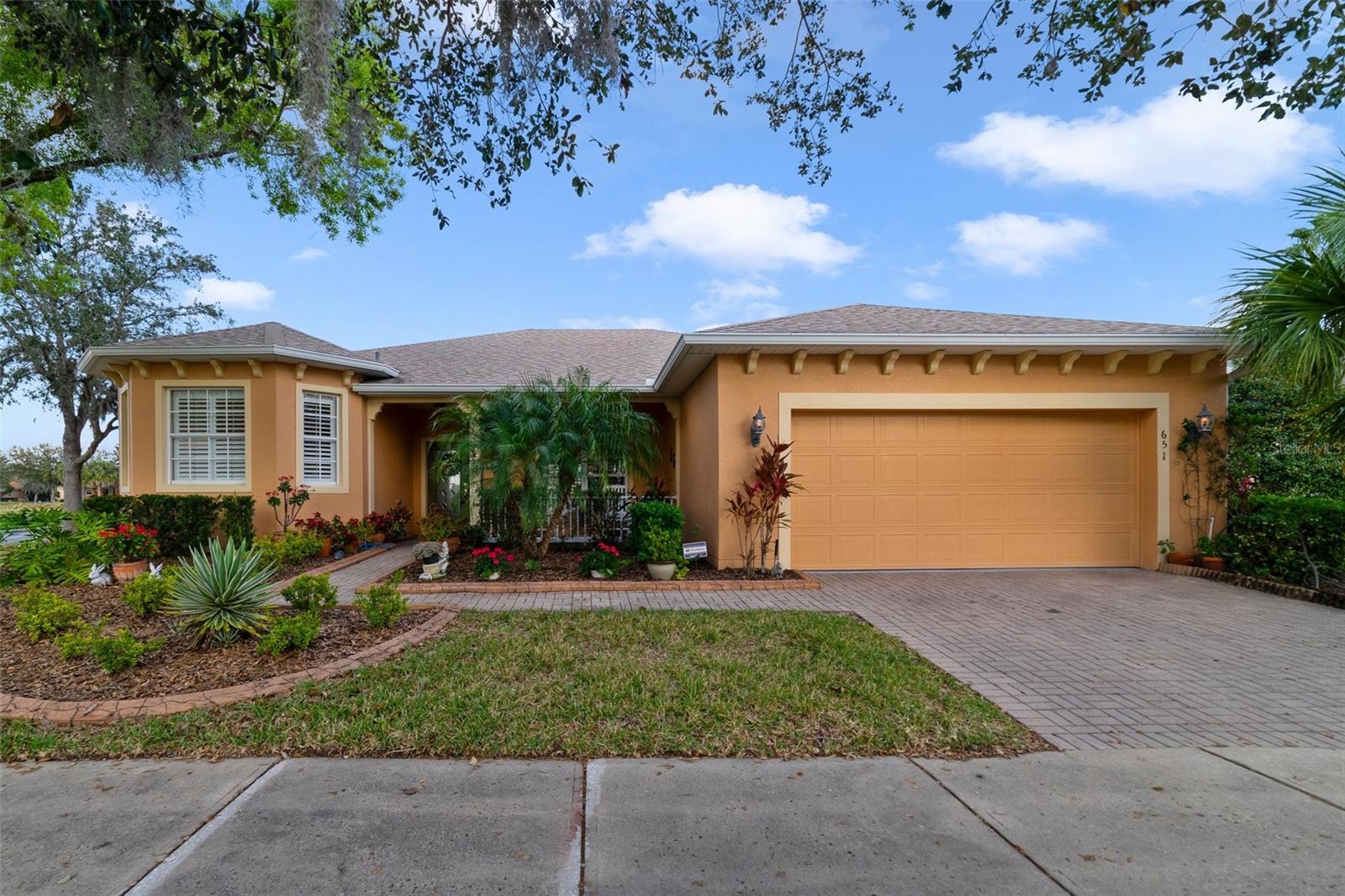 Check out this beautiful Carnegie Model that sits on a huge corner lot with water view and conservation lot frontage, just across the street from a heated satellite pool. The home boasts incredible features such as gourmet's dream kitchen with center island, granite counter tops and beautiful back splash. 42" wood cabinets adorned with crown molding  and pull out draws on the bottoms.  You don't know how great these are until you have them!! Kitchen has S/S Appliances, an under mount sink as well as a Reverse Osmosis water filtration system. 13" ceramic tile flooring in the kitchen and dining area as well as the laundry room and bathrooms - Entertain overlooking the beautiful view from the dinette windows to the water view out back. The Dining room, Living room, bedrooms and den all have Porcelain Tile flooring - Very tasteful color "Wood" planks. Recessed lighting and pendant lighting throughout the home - Pocket door in the hallway which will provide privacy to the second bedroom and bathroom. The huge den has a sliding glass door to the Florida room as well as built-in cabinets with a desk. Perfect workspace, or for the hobby enthusiast. The Florida room, which was built in 2018 has a Mini Split HVAC system, double pane and low E impact resistant windows. Just a beautiful space to enjoy the view of the sunrise over the water. The home has a 4 ton HVAC System from 2018 with a humidifier and a new roof in 2021. An AccuClean Air. Filtration system installed in 2020. THE home is located in the terra vista subdivision in beautiful Solivita -  LIVE THE Lifestyle - over 250 clubs and growing - 17 pickle ball courts, tennis courts, 2 golf courses, 3 restaurants, 2 state of the art fitness centers and 2 huge community pools. THE area has grown to plenty of shopping, hospitals, Sunrail station only 15 minutes away.