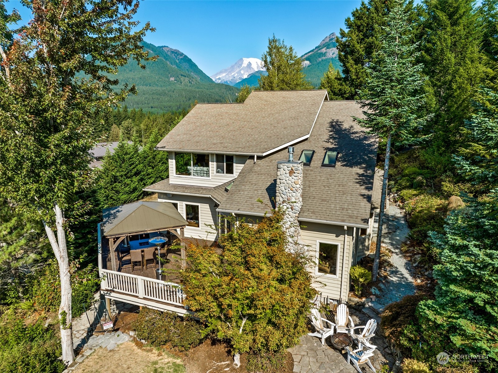 It's a perfect day to buy your dream home! 3-bed/2.25 bath home in gated neighborhood. Detached ADU with 1 bed/.75 bath & garage/storage below. Amazing views of Mt Rainier & Cowlitz Valley/Tatoosh Range. This property is less than a mile from downtown Packwood & has easy HWY 12 access. 25 minutes to Mt Rainier Nat Park/White Pass Ski Resort. 2.5 hours to SEA & PDX. Open concept living space with river rock fireplace. Fully equipped kitchen, featuring ILVE gas range, double ovens, granite counters/maple cabinets. Expansive outdoor deck space. New hot tub & gazebo. The detached ADU or "Alpenhaus" was recently remodeled and is currently a successful vacation rental. Guests love the views and relaxing sauna! Virtual tour & video available.