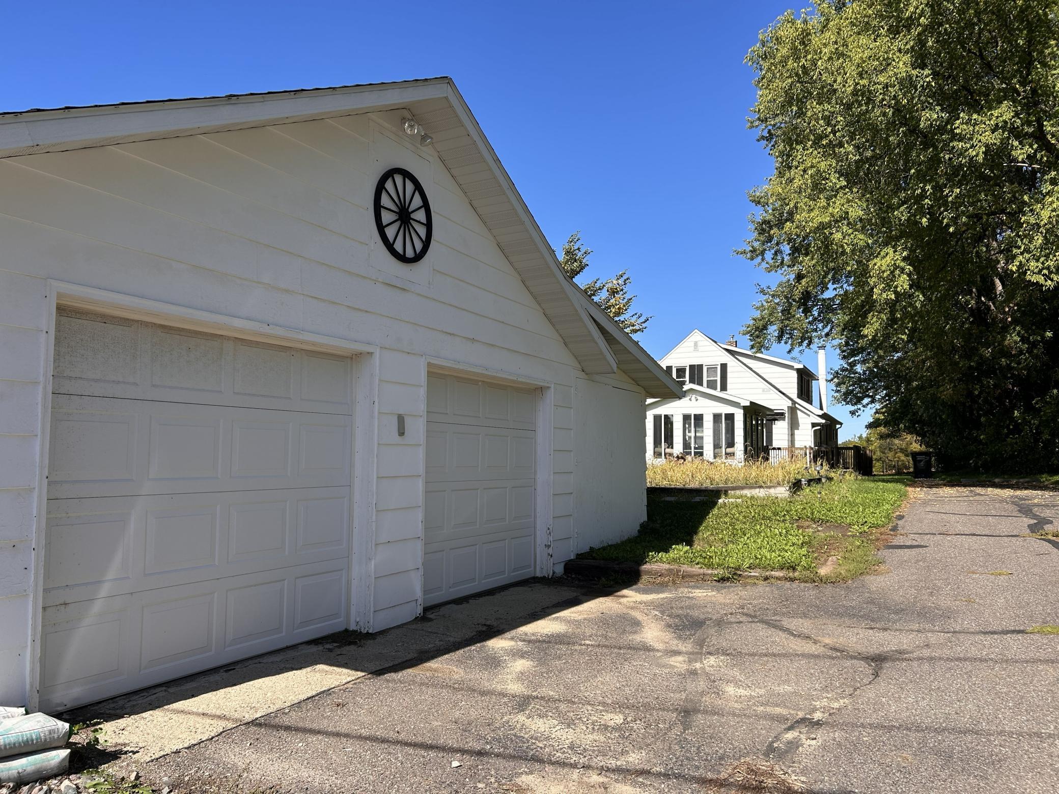 This beautiful, historical Holdingford home offers nearly 3,000 finished square feet with exceptional flexibility for a variety of living arrangements. The main level features original cherry woodwork, an inviting living space, an updated kitchen with granite countertops and a charming breakfast nook, two bedrooms, and a refreshed full bathroom. A main-floor in-law suite adds incredible versatility with its own kitchenette, 3/4 bath, and private entrance. Enjoy the bright sun porch off the deck, finished with warm cedar tongue-and-groove interior—perfect for relaxing or entertaining. The upper level includes a two-bedroom apartment with an updated kitchen and full bath, accessible from both the interior and a separate exterior entrance, making it ideal for multigenerational living or rental potential. Major improvements include , mini-splits providing heat and A/C (2025), full wall and attic re-insulation (2023), and updated bathrooms and upper-level kitchen. The property offers a total of four garage stalls, including a single attached garage and a three-stall detached garage with an insulated workshop. A rare opportunity to own a spacious, well-maintained, and highly adaptable home in the heart of Holdingford.