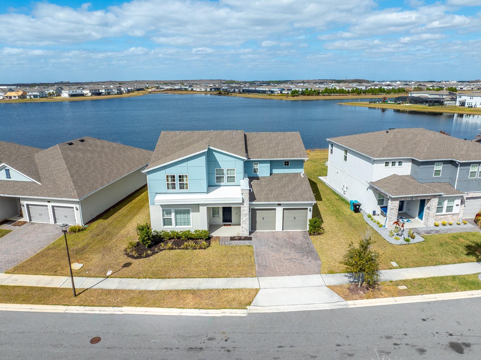 Waterfront luxury in the heart of Lake Nona! Welcome to this beautiful property with modern elevation located in the desirable Summerdale Park community in Lake Nona. This stunning home offers 4 bedrooms and 4.5 bathrooms, providing a rare more-than-1:1 bedroom-to-bathroom ratio ideal for modern living and hosting guests. Designed with elegance and functionality in mind, the home features a gourmet kitchen with built-in stainless-steel appliances, an oversized center island, quartz countertops, and 42" cabinetry, perfectly positioned within a spectacular open-concept floor plan highlighted by soaring volume ceilings and an abundance of natural light. The home showcases a spacious Primary Owner’s Suite featuring a large walk-in closet and a spa-inspired ensuite bathroom, creating a true private retreat. Beautiful premium laminate flooring runs throughout the entire home, NO CARPET anywhere. A versatile flex room offers the option of a 5th bedroom, home office, or media space. Enjoy seamless indoor-outdoor living with a large covered lanai overlooking tranquil water views, complete with pre-plumbing for an outdoor kitchen, all set on a generous lot. Additional highlights include a 3-car tandem garage and thoughtfully designed living spaces ideal for both everyday comfort and entertaining. Summerdale Park amenities include a resort-style community pool, a scenic boardwalk to the water, and a dock, creating a true lifestyle-focused community perfect for relaxing and enjoying the Florida outdoors. Perfectly located just minutes from Lake Nona Town Center, Boxi Park, premier dining, shopping, and entertainment, as well as Wave Hotel, Lake Nona Medical City, and the USTA National Campus. With easy access to Walt Disney World Resort and Universal Orlando Resort, this location truly has it all. Don’t delay, schedule your private showing today and experience Lake Nona living at its finest!