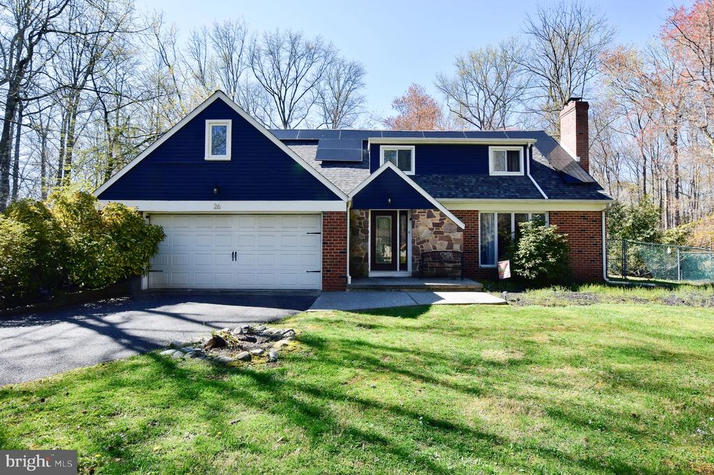 Welcome to 26 Maine Trail, a spacious 5-bedroom, 3.5-bath home featuring a private in-law suite with its own entrance. From the extended driveway to the brick exterior with a stone-accented entry, this home offers strong curb appeal from the start. Inside, hardwood floors flow through the sun-filled family and dining rooms, highlighted by oversized windows and a wood-burning fireplace. The dining room opens to the backyard, creating an easy indoor-outdoor connection. The eat-in kitchen features stainless steel appliances and granite countertops, while the adjacent living room offers a warm, inviting feel with darker flooring and exposed beams. A standout feature is the private in-law suite, accessed through a bright sunroom with vaulted ceilings and wood-paneled walls. This space easily accommodates a king-sized bed and includes a separate living area with its own fireplace, a full bathroom, expansive walk-in closet, and direct access, ideal for multi-generational living or guests. Upstairs, you’ll find hardwood floors throughout, a generously sized primary suite with a recently renovated full bath, and three additional well-proportioned bedrooms with an additional hallway full bathroom. Step outside to enjoy the in-ground pool and patio, thoughtfully positioned to complement the home’s layout and maximize outdoor living. Major updates include a newer roof, gas heater, central air, and hot water heater (all within the past 10 years), offering added peace of mind. Conveniently located near shopping, dining, Virtua Hospital, and major highways, this home combines space, flexibility, and location in one exceptional opportunity.