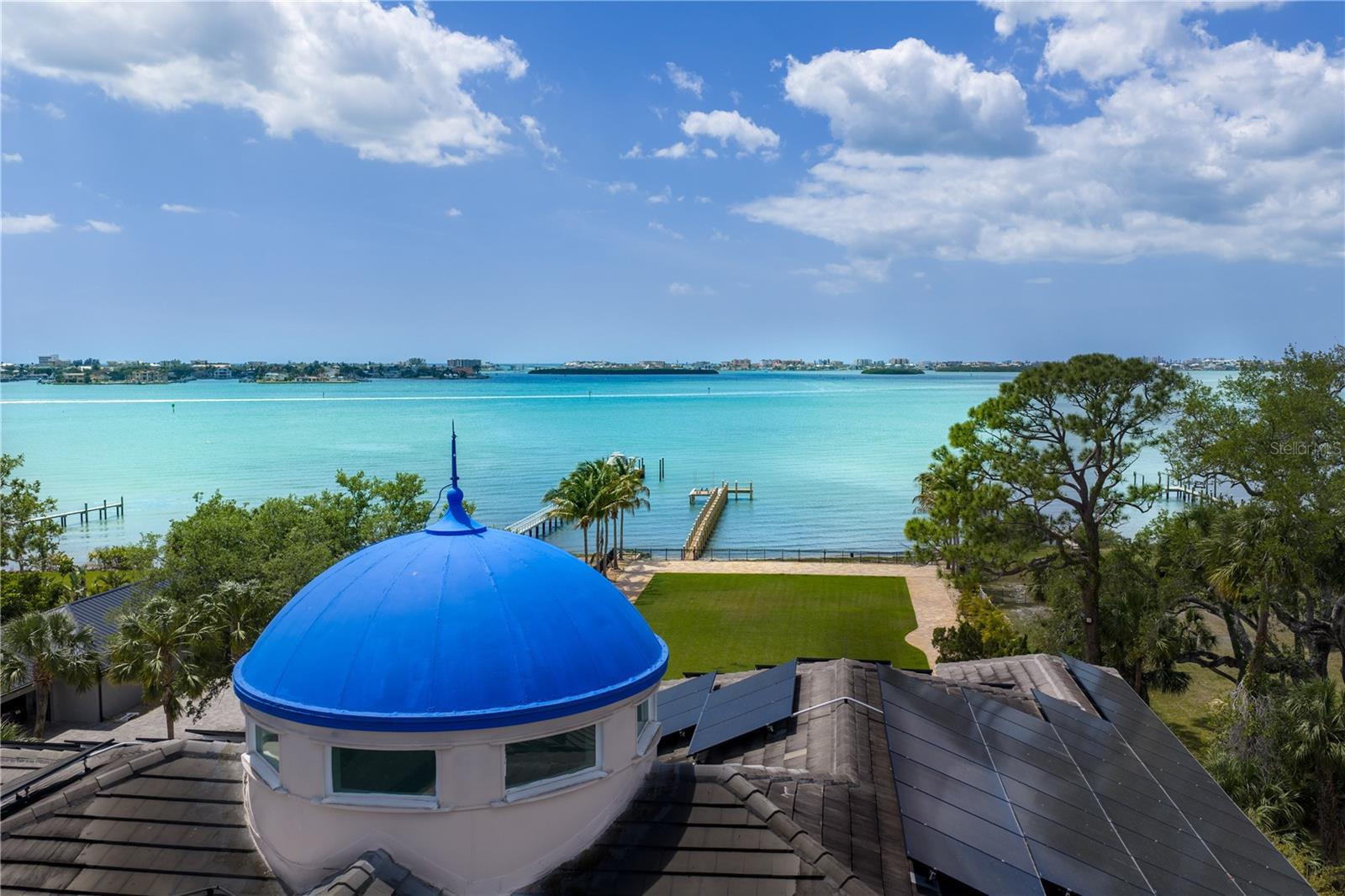 Palazzo Sul Mare is a rare waterfront estate in St. Petersburg’s coveted Jungle Prada neighborhood, offering over 19,000 square feet under roof and more than 10,000 square feet of interior living space on over 1.5 acres along the Intracoastal Waterway. Built in 2020, this residence blends modern construction with timeless European-inspired design—an offering rarely found in this market.A grand motor court and porte-cochère create a secure, estate-style arrival. An imported limestone exterior, along with wrought iron detailing, a distinctive blue dome, fountain, marble statuary, and mature oak trees, establishes a timeless setting surrounded by tropical landscaping and the neighborhood’s iconic peacocks. Inside, a dramatic domed rotunda crowned by a crystal chandelier anchors the home, featuring inlaid marble flooring and dual sweeping marble staircases. The layout captures water views throughout, with a gallery-style corridor ideal for art, a grand piano, or entertaining. Marble archways and columns, gold and iron balustrades, and detailed ceilings create a striking architectural presence, while illuminated art niches enhance the home’s scale and design continuity.Custom millwork, fresco-style ceilings, and imported marble flooring span all three levels. The kitchen features a full suite of Thermador appliances, including a 60-inch gas range, integrated refrigeration, and built-in coffee system, along with quartzite surfaces and an illuminated onyx island. A custom Chihuly-style installation of hand-blown glass creates a focal point above, while the curved glass dining area frames panoramic water and pool views with space for large-scale entertaining.The residence includes multiple bedroom suites, several exceeding 1,000 square feet, many with spa baths, expansive closets, and private lanais with water or garden views. The main-level primary suite offers a marble bath with Phylrich fixtures, sauna, soaking tub, multiple vanities, and panoramic water views beneath a custom fresco ceiling.A private office on the main level features paneled walls, built-ins, an ornate stone fireplace, and balcony access. The upper level includes a club-style lounge with a quartzite waterfall bar and sunset views. The home spans three levels with elevator access and marble staircases, with laundry rooms on multiple levels.Outdoor living includes a zero-entry pool, lap pool, 2 spas (hot and possible cold), 5 terraces, courtyards, fire pit, private sandy beach, citrus trees, and a wide rear lawn. The grounds offer flexibility for a guest house or ADU, sport court, cabana, or greenhouse. The private dock includes a 10,000-lb lift, additional lifts for personal watercraft, a wet slip for a yacht, and direct Gulf access.Built for longevity with reinforced pier-and-beam construction on pilings, impact-rated windows and doors, and a stone exterior. Designed with engineered elevation, the residence features elevated living areas (approx. 7.7’ first level and 20’+ upper levels), with no reported water intrusion. Smart home technology, full security camera coverage, solar power, saving thousands per month in electricity, 4 HVAC systems (2023) with 10-year warranties, and 2 whole-house generators for efficiency and reliability.Garage capacity for approximately 6 vehicles includes additional space for a workshop, recreation, or gym with over 5,000 square feet of lower-level space. A rare combination of scale, craftsmanship, and waterfront presence.