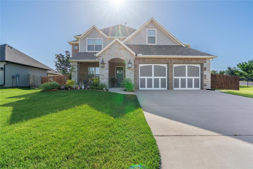 This gorgeous corner lot home with 3 car tandem garage in Edmond Schools is awaiting its newest owner, and that could be you! This home showcases beautiful color schemes, wood floors in the living area, and several windows throughout, allowing natural light to flood the space! The living room offers a stacked stone fireplace, built-ins on both sides, and it's open to the kitchen, making this just the spot for entertaining. The kitchen features granite countertops, a large center island with a breakfast bar, a built-in gas stove with an overhead vent, stainless steel appliances, and under-cabinet lighting. Your primary bedroom is complete with crown molding and a private en-suite, including a claw-foot tub, double vanity, walk-in shower, and a walk-in closet. This home is also equipped with an upstairs game room and a study nook! Relax outside in the backyard underneath the covered patio and enjoy the warmth of the outdoor fireplace! You won't want to miss your chance to call this one "Home"!