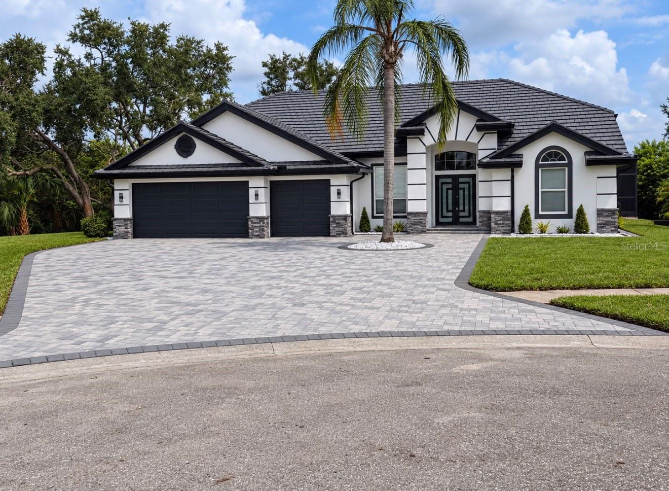 Welcome to 9701 Port Colony Way, an extensively renovated residence offering an exceptional combination of space, privacy, modern design, and outdoor living on a highly desirable Tampa location.Featuring 4 bedrooms, 3 full bathrooms, plus a dedicated office, this home has undergone an impressive transformation with approximately $330,000 invested in renovations and improvements.Major upgrades include a NEW TILE ROOF, a NEW 5-TON HVAC SYSTEM, beautiful new porcelain tile flooring throughout, and three completely remodeled bathrooms featuring custom glass enclosures, modern vanities, and LED mirrors.At the heart of the home is a stunning OPEN-CONCEPT KITCHEN designed for both everyday living and entertaining. It features sleek cabinetry, a large center island, and a complete NEW SET OF KITCHEN APPLIANCES, creating a modern centerpiece for the home.The exterior has received an equally impressive transformation. One of the standout improvements is the NEWLY EXPANDED PAVER DRIVEWAY, completely redesigned with new pavers to create a wider, more attractive entrance while providing significantly more parking space and enhancing the home’s curb appeal.The backyard has been completely transformed with a BRAND-NEW SWIMMING POOL and NEW SCREENED ENCLOSURE. The pool is entirely new and is equipped with a SALTWATER CHLORINATION SYSTEM featuring a salt cell for easier maintenance and enhanced water quality.The landscaping has also been extensively refreshed with NEW SOD around the property, significantly enhancing the home’s curb appeal and outdoor surroundings. A NEW SPRINKLER SYSTEM was also installed to provide convenient irrigation and help maintain the newly established lawn.Additional major improvements include NEW GARAGE DOORS, NEW SOFFITS AND GUTTERS throughout the home, further contributing to the extensive exterior renovation.The attention to detail continues throughout the property with fresh interior and exterior paint, lighting, doors, ceiling fans, bathroom vanities, and LED mirrors.Move-in ready and extensively transformed, this is a property that truly needs to be seen to appreciate the scale, quality, and attention to detail of the renovation.