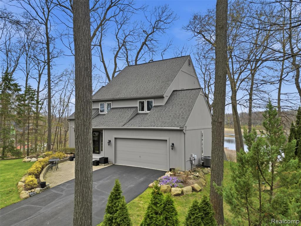 Welcome to your dream lakefront retreat in Brighton! This beautifully maintained 4-bedroom, 3 full and 1 half bath home offers over 2,700 total finished square feet, including a finished walkout basement, all set on 115 feet of frontage on all-sports Crooked Lake. Step inside to find fresh paint throughout and a bright, open layout filled with natural light from an abundance of windows. The living room features vaulted ceilings and a cozy wood-burning fireplace, creating the perfect space to relax or entertain. The kitchen is designed to impress with stainless steel appliances, granite countertops, a tile backsplash, and a large center island offering plenty of prep space and seating. Upstairs, the spacious primary suite boasts stunning lake views and a private walkout deck—ideal for morning coffee or evening sunsets. The en-suite bathroom includes a luxurious sunken tub and a step-in full tile shower. The finished walkout basement adds approximately 550 square feet of additional living space, complete with another bedroom featuring an egress window—perfect for guests or extended stays—and direct access to the back deck and lakefront. This home has been thoughtfully updated and well maintained, featuring a newer A/C and furnace (2019), boiler (2018), and an on-demand hot water system. Additional improvements include a new water pressure tank installed in 2025, generator wiring for added peace of mind, and solid core doors throughout the home. Enjoy lake living at its finest with plenty of outdoor space for entertaining, relaxing, and taking in the beautiful surroundings. Neutral tones throughout make this home truly move-in ready. Don’t miss your opportunity to own a slice of waterfront paradise on Crooked Lake!