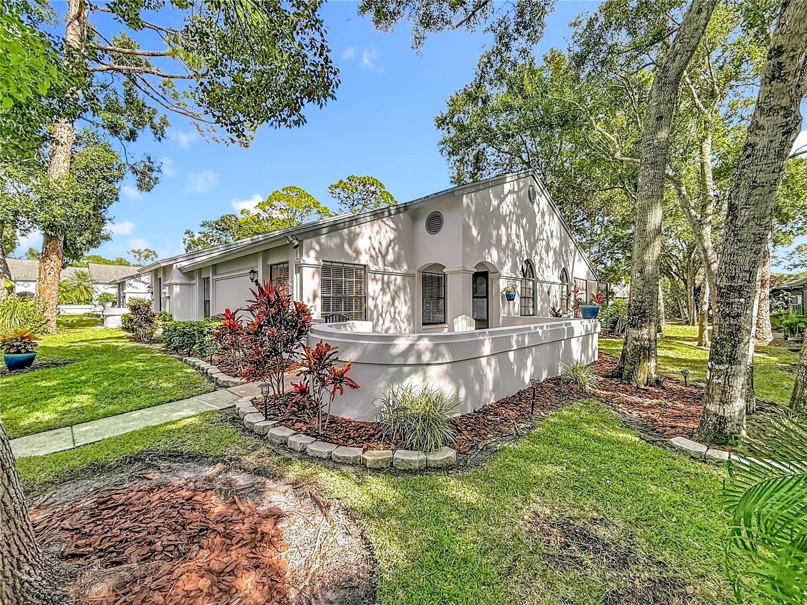 Location, Location, Location! MUST VIEW VIRTUAL TOUR! Beautiful, 2/3 Bedroom, 2 Full Bath One Story Maintenance Free Villa Nestled in Desirable, "The Clearing" Enclave of Lansbrook! Rarely Available End Unit is the Largest Villa in The Clearing with 1426 Sq. Ft. Beautiful Cul-de-Sac Location Backing to Pond. This Open Floorplan Boasts 10 Ft. Ceilings in the Great Room with Beautiful Arched Windows. The Eat-In Kitchen Includes Stainless Steel Appliances, Neutral Tile Flooring (Large 24 Inch), Pantry, and Plenty of Cabinet and Counter Space. Spacious Master Bedroom Has En Suite Bathroom, Linen Closet, and Large Walk-In Closet. The Split Bedroom Floorplan Features a Large 2nd Bedroom, Full Hall Bath and Linen Closet. The 3rd Bedroom Option is Currently Being Used as An Office and Has French Doors and Access to Lanai! The Screened in Lanai Has Beautiful Views of the Landscaping and Pond to Enjoy Morning Coffee While Watching the Sun Rise Through the Palm Trees and Relaxing Evenings Listening to the Peaceful Fountain...There is Plenty of Closet and Storage Space with 2 additional Hall Closets, an Interior Attic with Pull Down Stairs, and Additional Locked Storage Closet in the Back....Home Updates include Newer Hot Water Heater (2018), Newer Washer/Dryer (2019), Newer Refrigerator (2019), Resurfaced Courtyard and Lanai (2020), Newer Lennox 2.5 Ton AC (2018), New Blower Motor Fan (2023), New AC Condenser Coil (2023). The Affordable HOA Fee Covers Roof! (New Roof 2017), Exterior Paint, Water, Trash, Lawncare and Community Pool! Beautiful Area to Enjoy Walking, Biking, and a Less than 1 Mile to YMCA, Lansbrook Golf Course & Shopping! Easy Access to Beaches, Parks and Tampa International Airport! Pet Friendly, Dogs OK...No Size or Weight Restrictions! NO Flood Insurance Required...Furnished is Optional!
