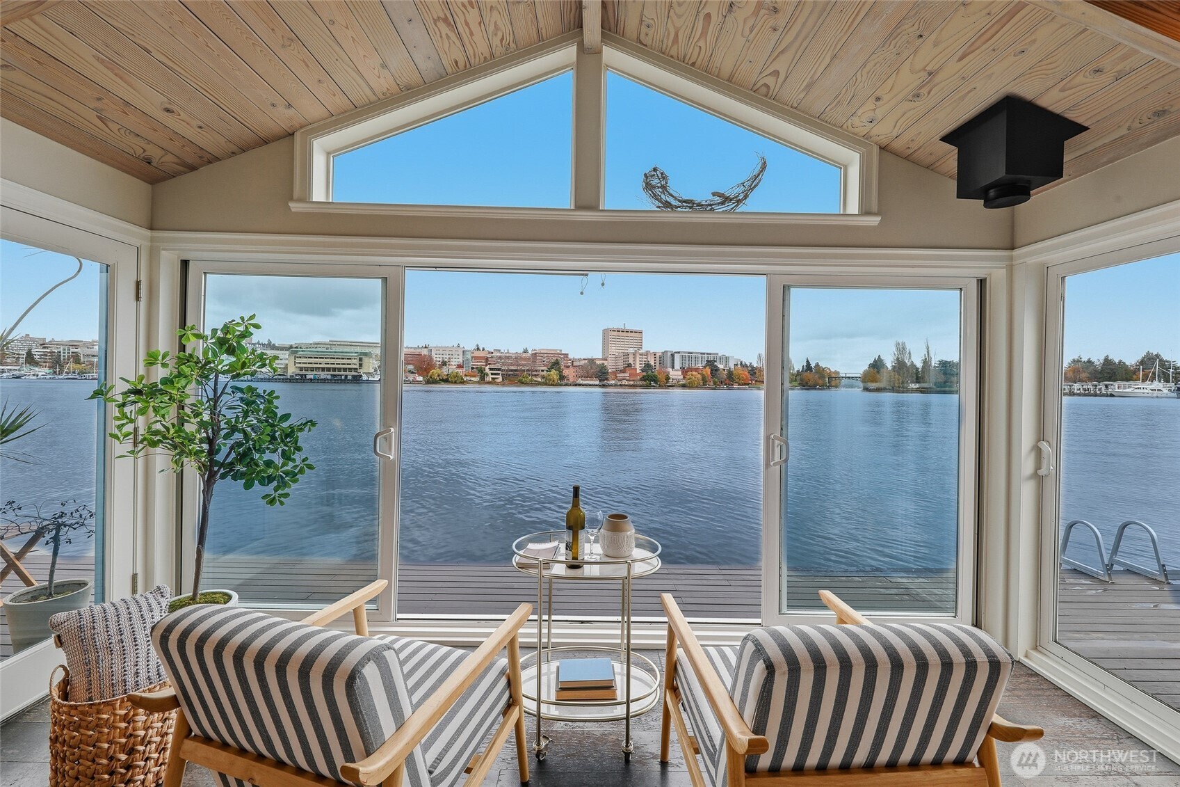 The lake reflects the sky in this light-filled front row floating residence, featuring an expansive living room & open kitchen beneath beautiful vaulted ceilings. A true rarity, this home provides single level living with beautiful wood floors throughout. All 3 bedrooms enjoy views framed by brand-new windows, perfect for watching winter migratory birds & all the water action. Loads of storage including attic access. Enjoy 38 feet of low-bank bulkhead waterfront & 2 outdoor seating areas—including one directly off the primary bedroom.  Fresh interior and exterior paint enhance the timeless design by architect Eric Hogeboom. Includes a dedicated boat slip, completing this exceptional waterfront lifestyle.