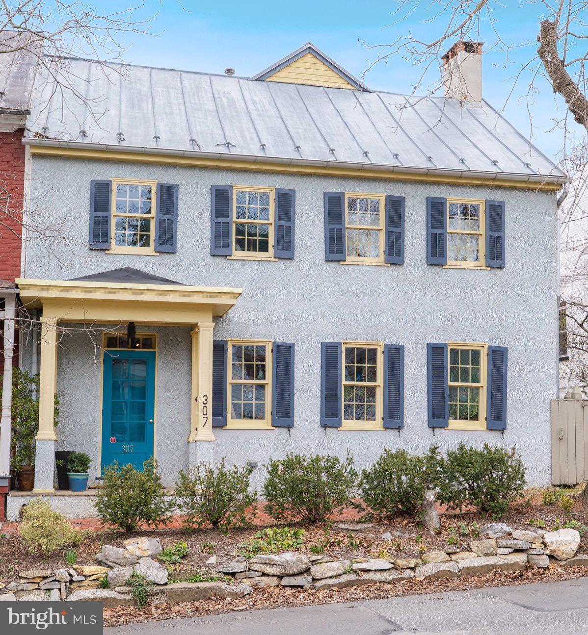 Nestled in the heart of historic Shepherdstown, a 2026 recipient of the USA TODAY Readers’ Choice Top 10 Award for Best Historic Small Towns, 307 W German Street seamlessly blends timeless character with modern potential, offering a unique opportunity for those seeking a home rich in charm. The historic front presentation draws you in; but the rear, alley garden entrance is where you will fall in love with its flagstone pathways, stone benches, fountain, and vibrant pollinator garden.  Immerse yourself in the home's vibrant, mature landscaping as you meander the stone paths.  Once inside, you are greeted by a spacious, open floor plan integrating the kitchen, dining, and living areas.  The recent addition of the generously sized, screened-in porch with infrared heaters and teak floors provides for multi-seasonal use well into the fall and cool early spring days.  Follow along the numerous improvements during the sellers' tenure at this historic gem.  From a front view, find hand-forged porch grab bar, house numbers, and historic shutter dogs on the windows.  The long-traveled brick sidewalk was enhanced with underground drainage piping while the orginal bricks were leveled and lined with new landscaping.  Just inside the front, hardwood floored entrance you are drawn into the heart of the home at the kitchen.  Here you will find granite countertops, built-in shelving, large center island with farm sink, wrought iron cabinet pulls and a cork wall coffee station all pulled together with updated appliances.  Crown molding was generously added throughout the kitchen, dining and living rooms. When not relaxing under the infrared heaters on the screened-in porch, snuggle up next to the pellet stove in the living room all while enjoying views of the vibrant backyard landscaping. On the second floor you will find two generously-sized bedrooms and a possible additional bedroom currently used as an office/family room.  A private third floor bedroom is tucked away behind a beautiful 15-paned glass door.  The bright, window-lined primary bedroom boasts an ensuite primary bathroom featuring a spacious walk-in shower with custom made windows, a historic vanity with raised sink and separate soaking tub.  The closet-lined hall between the primary bedroom and bathroom includes the laundry area and features built-in shoe racks and new hardwood flooring throughout.  Black-out shades and crown molding are featured throughout the second and third floors.  Downtown parking woes are solved with the rear alley access to three parking spaces, including two covered spots behind the home’s matching potting shed.  Interior storage options include an abundance of closets throughout, along with the unfinished basement and walk-up attic.  Further improvements include an electric pump in the cistern to allow for convenient watering of gardens and dual heat/air pump (zoned for the first floor and second unit for the second and third floors).   Whether you're looking to take a leisurely stroll on the 184.5 mile C & O Canal Towpath or enjoy nearby dining & entertainment options Shepherdstown is waiting to be explored.  With its historic charm, community-focused lifestyle, and convenient location, this property is more than just a home; it's an invitation to be part of the oldest recorded town in West Virginia with easy access to neighboring Northern Virginia, Maryland and DC.  Nearby Shepherd University offers a range of activities to the community including a Wellness Center, the Life Long Learning program, as well as athletic events, concerts, lectures and plays throughout the year.   Living in Shepherdstown embraces a lifestyle filled with community and local charm where neighbors become friends and community events bring everyone together.  Due diligence for all information presented in the listing;  including, but not limited to measurements, architectural style, age, building materials, lot lines, utilities, and finishes.