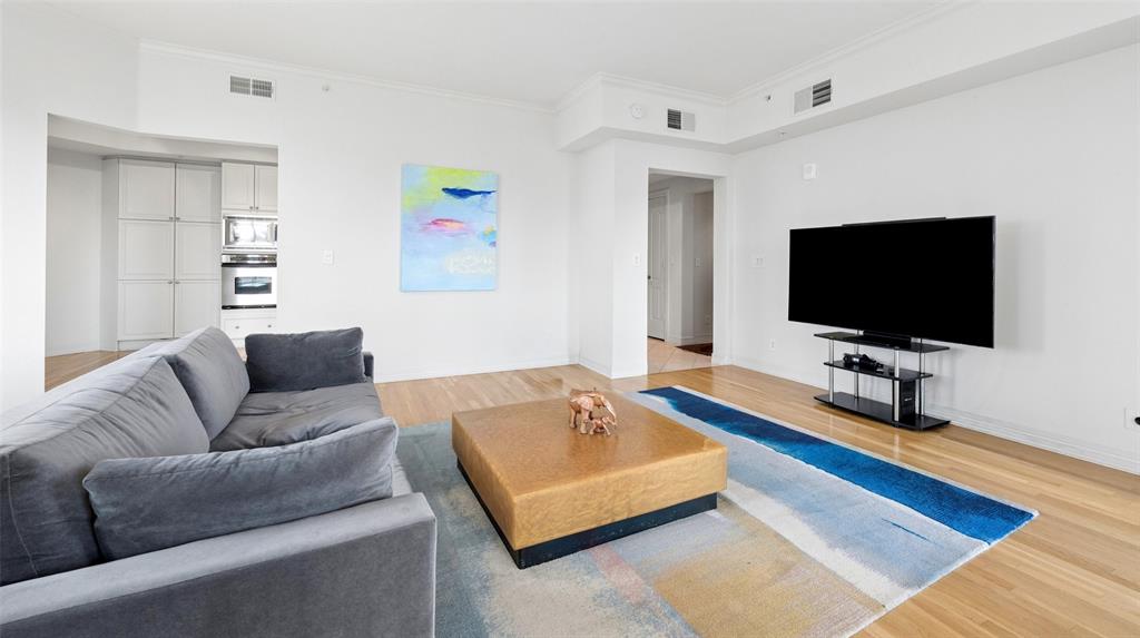 Enjoy beautiful views of Turtle Creek Park and historic Turtle Creek Boulevard from this light filled corner unit at The Mayfair.  The owner painted and updated the wood floors and kitchen cabinets for a transitional decor.  Mayfair residents enjoy a terrific location and some of the finest resident amenities in the neighborhood.  The popular Sky Club is available to enjoy downtown Dallas views and overlooks Turtle Creek Park and may be reserved for residents wishing to reserve for entertaining family and friends.  The Mayfair Room features views of Northwest Dallas.  The Third Floor includes the popular coffee bar where neighbors enjoy coffee, juice and papers in the morning before heading for a workout in The fitness room.  The beautifully landscaped garden terrace includes the pool, hot tub and grills for resident barbecues.  Fantastic urban location with easy access to The Katy Trail, Uptown, Downtown, UT Southwestern, Baylor, restaurants and shopping.  Every condo comes with two deeded parking spaces and storage space.