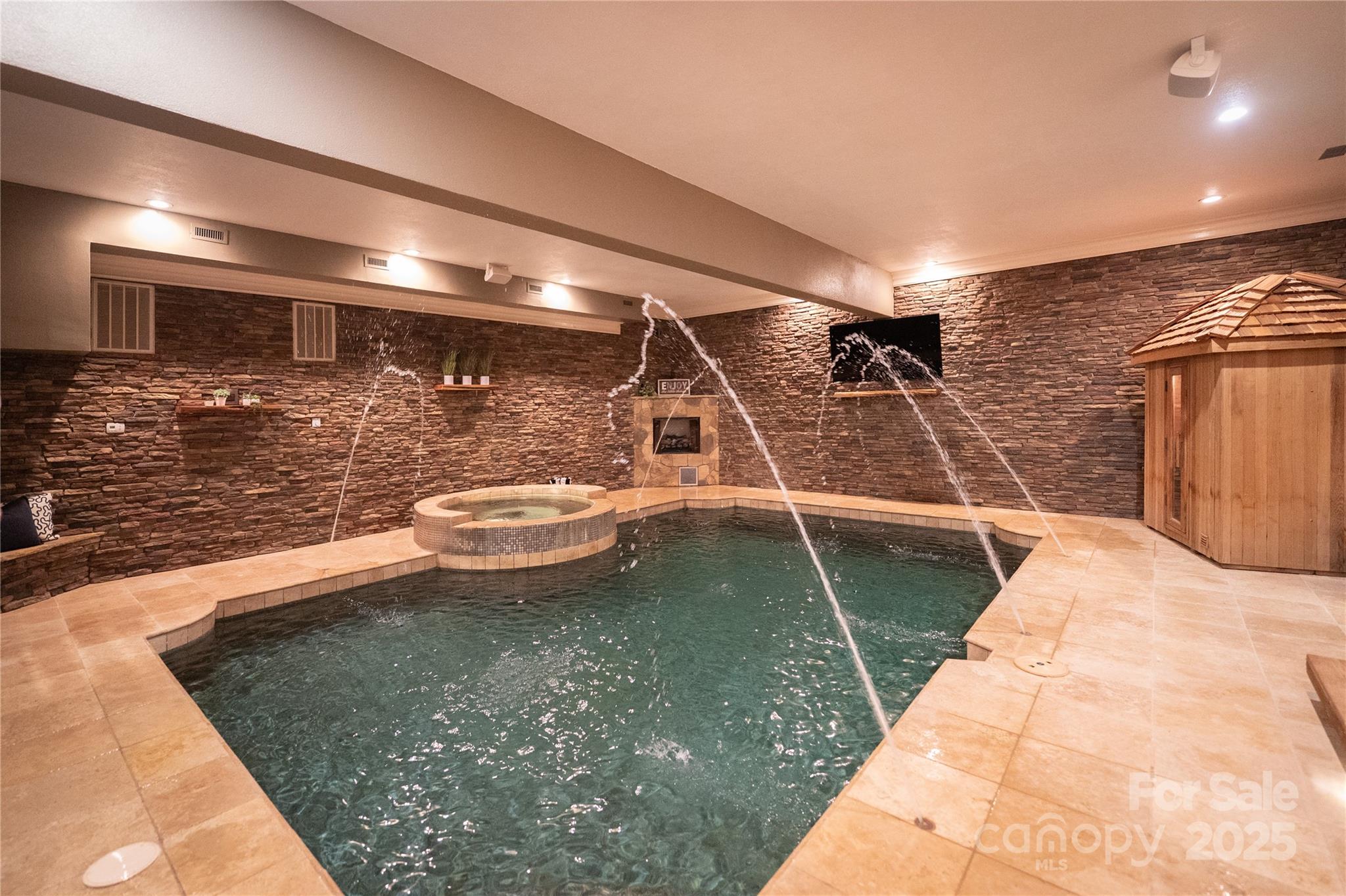 Welcome to Badin Lake where luxury lake living also brings a golfers paradise with plenty of entertainment in this 10,144 square foot waterfront home. Nestled on the pristine shores of Badin Lake with over 200 feet of private shoreline, this premier waterfront retreat offers captivating lake views and effortless lake living. Just steps from the renowned Old North State Club, ranked among Golf Digest’s top courses, the property features a lighted dock with a boat lift and three Jet Ski lifts. An exceptional indoor pool retreat awaits with travertine floors, cedar storage, dry sauna, stone fireplace, and hot tub, designed for year-round enjoyment in a peaceful setting. Four A/C units were replaced in 2020 and this house has numerous features including a Sonos Sound System and HikVision security system. Please see that attached features list for more details. The home is located in the gated community of Heron Bay.