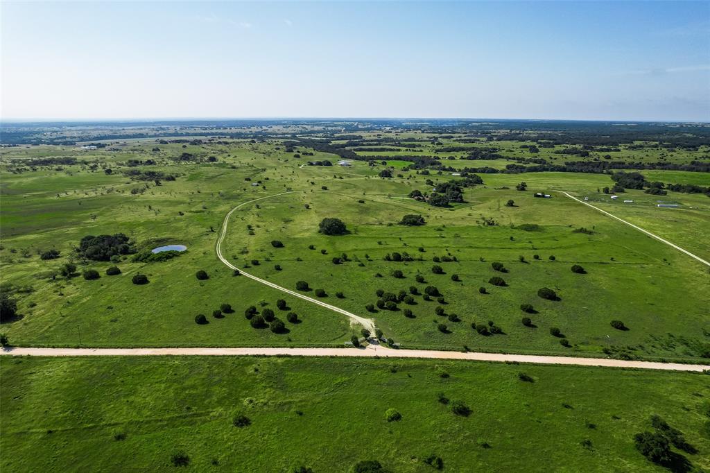 Welcome to your private 79-acre retreat in Erath County, perfect for hunters, outdoor enthusiasts, or anyone seeking privacy and tranquility! This expansive property is fully fenced and boasts two serene ponds. You'll find the ideal spot to build your dream home with spectacular countryside views, already equipped with a second well, septic system, and electric meter. For storage and hobbies, there are two barns: one is perfect for all your recreational toys, and the other is a four-stall horse barn with additional space for equipment storage.The existing home is a comfortable 3-bedroom, 2-bathroom, 2-car garage layout, offering 2,265 square feet of living space. It features a large, sunken living area complete with a cozy fireplace and built-in shelving. Formal dining area and split bedroom floor plan. Don’t miss this opportunity!