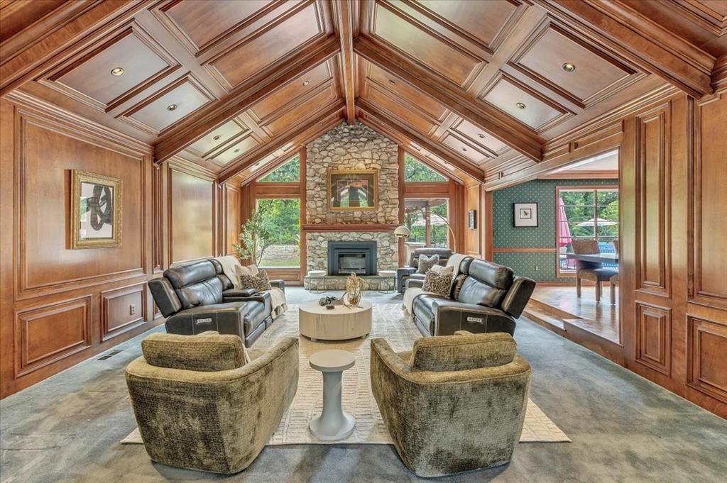 Nestled in the classic and highly sought-after Arrowhead Hills neighborhood, this home surrounded by pristine nature, offers timeless charm and modern comfort on 2 private wooded acres. A winding driveway leads you to this spacious 4-bedroom, 2.5-bath home featuring a cathedral-style living room with rich cherry paneling and a grand marble entry. Enjoy multiple gathering spaces including a formal dining room, a cozy den with fireplace, and an eat-in kitchen with parquet floors. Step outside to your backyard oasis—complete with a gunnite swimming pool, outdoor kitchen, and mature trees offering peace and privacy. An entertainers dream with a lving space overlooking the pool.  Additional highlights include two wells, a workshop in the carport with a lockable pull down door, and classic details throughout. A rare opportunity in one of the area's most established neighborhoods.