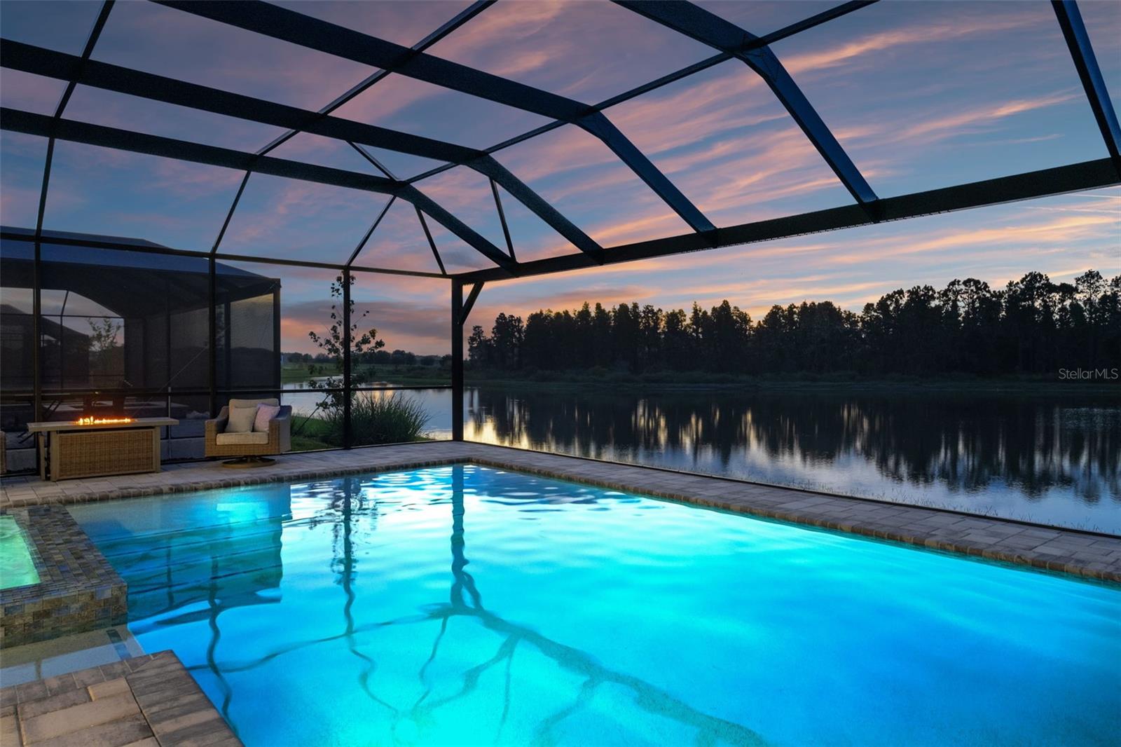 Huge Price Reduction! Back on Market after the holidays. 2026 upgrades include an induction cooktop, pot filler and slim microwave. Think you’ve seen custom homes? Think again. Imagine owning a home where every inch is designed not by a builder, but by an artisan. This is a one-of-a-kind residence where custom craftsmanship shines in every corner, trim, finishes, and details you won’t find in any builder-grade home. It offers style, scale, and serenity.Located in the Whispering Oaks Gated Community with no CDD fees and featuring four bedrooms, a bonus room home theater, a designated office, double laundry rooms, and four bathrooms, with the primary suite on the first floor, this incredible home also has a stunning pool with panoramic preserve views, a three-car garage, and so much more, all within over 5,000 sq. ft. of living space (4,200+ heated sq. ft.).Customized with crown molding and chair rail/wainscoting in every space. You’ll love the kitchen with soft-close cabinets and drawers, quartz waterfall-style countertops, a built-in oven, and tile flooring throughout. The living room features double screens so you can watch two games at once, while the rest of the family enjoys movie night upstairs. Notice the crystal chandeliers, custom closet shelving in the bedrooms, coffered ceilings, automatic Roman shades, and countless other thoughtful details. The home theater is upgraded with a 150-inch screen and built-in 7.1 surround sound with digital THX and subwoofer.Step outside… the pool overlooks a peaceful pond, offering views as rare as the home itself. There’s an outdoor kitchen with a grill and a large screened-in lanai, perfect for enjoying the Florida sunset. This isn’t just a house—it’s a lifestyle upgrade.The Whispering Oaks community has low fees and no CDD, only $94 a month for a gated community with a park and playground and located near great schools. Homes like this aren’t made—they’re crafted. And they almost never hit the market.Located minutes from Overpass Rd./SR-75, for a quick ride restaurants and Downtown Tampa. This home is located in the Whispering Oaks Community, near the Publix Plaza at Innovation Spring and 2 minutes from the local Starbucks and Chick Fil-A. The HOA monthly fee is only $94 per month. The closest Elementary Schools are Innovation Preparatory Academy, Watergrass Elementary School & Wesley Chapel Elementary. The Kirkland K-8 Charter School is just a few blocks away The closest middle school is Thomas Weightnman Middle School. The nearest high schools are Kirkland Academy of Innovation High School and Wesley Chapel HS. This home is located about 10 minutes away from KRATE (the new outdoor mall), 35 minutes north of Downtown Tampa, 45 minutes from Tampa International Airport, and 90 minutes from Orlando and Walt Disney World theme parks.Full list of upgrades available upon request. Video tour available on YouTube and all the social media platforms, search by address. Buyer Tours available 7 days a week. All Buyers must be accompanied by a Licensed Real Estate Agent and must show a copy of the Home Loan Pre-Approval or a Proof of Funds letter from teh bank, before confirming a tour. No bank account screenshots will be accepted.