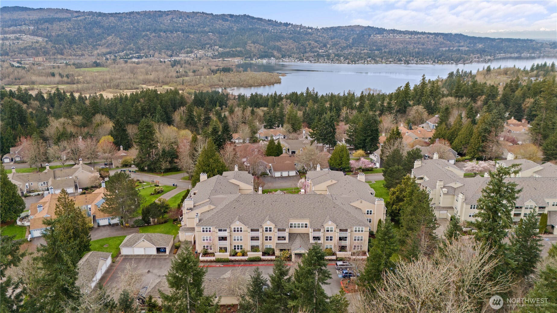 Care-free living awaits in this beautifully remodeled top-floor condo featuring 2 bedrooms, 2 baths, and two private covered balconies in the premier 55+ Providence Point community in Issaquah. The dreamy kitchen shines with stainless steel appliances, quartz countertops, RO system, under-cabinet lighting, and classic shaker cabinetry. Enjoy an open-concept living and dining area with access to an east-facing balcony—perfect for morning coffee and cool afternoon shade. The spacious primary suite offers a second covered balcony, a generous walk-in closet, and an updated bath with a step-in shower. A thoughtful split-bedroom layout places the second bedroom and bath on the opposite side of the home for added privacy. Smart storage solutions include custom pull-out shelves in the hall closet, a space-saving spice rack, and an additional storage room just down the hall. A convenient 1-car garage adds ease to daily living. The Pacific Building—Washington Village’s newest—offers guest parking, inviting gathering spaces on every floor, and a west-facing patio ideal for enjoying afternoon sun and friendly conversation. Experience independent living surrounded by vibrant amenities: indoor pool, clubhouse, fitness classes, tennis, pickleball, putting green, pea-patch gardens, scenic walking trails, and a full calendar of social, cultural, and recreational events.