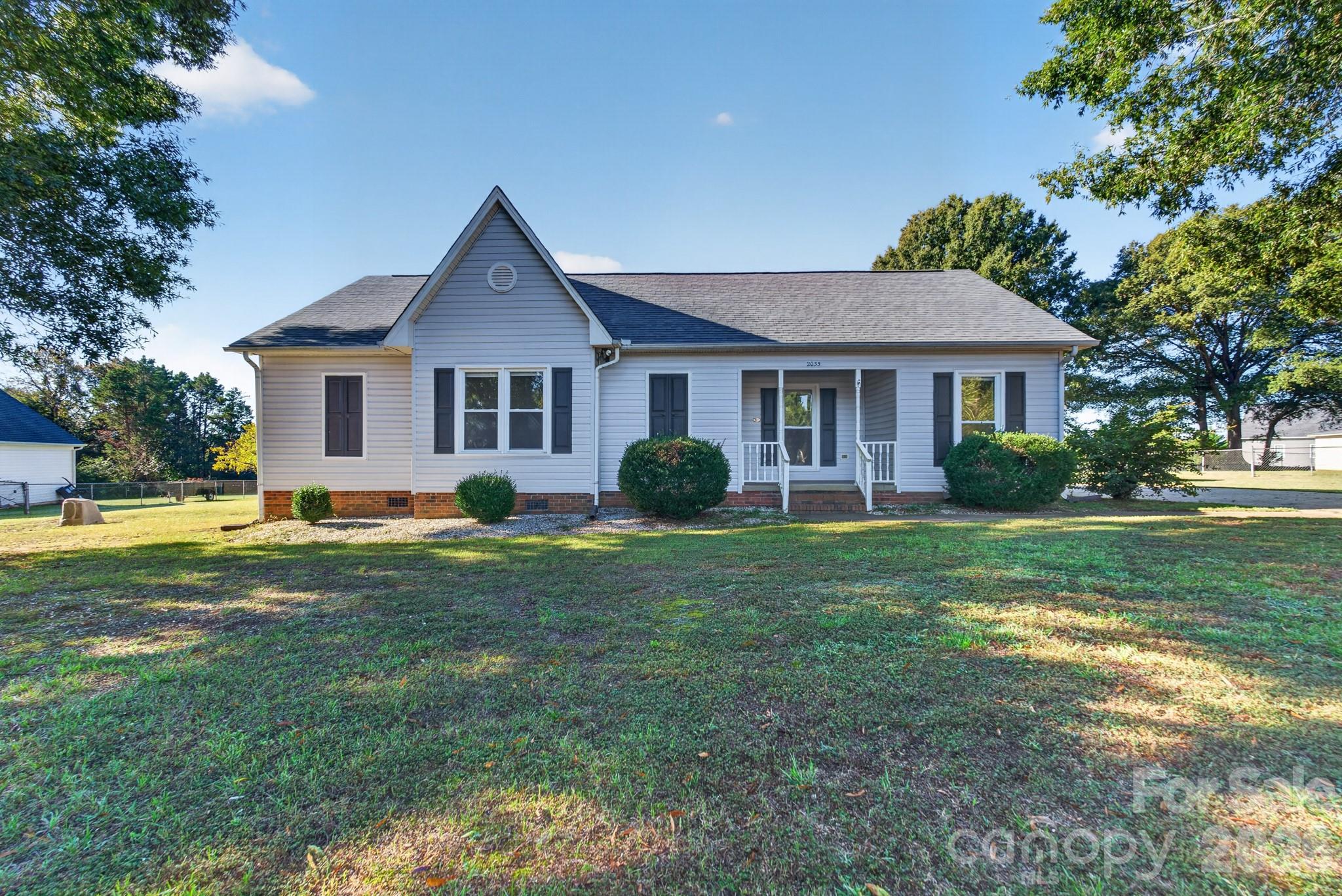 This home has been well-loved for many years, but is now ready to welcome new owners.  With three bedrooms and two full baths on one level, it is an attractive floor plan for many buyers. Entertain guests in the spacious vaulted family room or grab a book and cozy up by the gas log fireplace.  Enjoy preparing meals in the fully-equipped kitchen and gather around the table in the separate dining room with access to both the kitchen and family room.  The recently updated deck is the perfect spot to relax or visit with friends as you overlook the spacious backyard.  A detached 20’ x 20’ garage  and a stand-alone storage building are wonderful additions to this home.  Located on 0.71 acres, with no HOA, and no city taxes, this one certainly needs to be on your list to see!  Although there may be some cosmetic updates needed, the previous owners have replaced the roof (2024), the HVAC (2024), and the exterior siding (2025), taking care of the major improvements.  It is ready for you to add your personal touches as you make 2035 Cardinal Hill Drive your new address!
