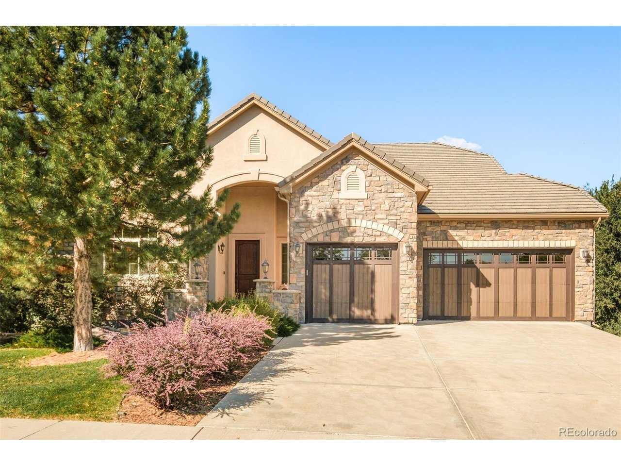 Poised in coveted Applewood, this corner ranch-style residence offers elevated living with mountain views, generous indoor-outdoor spaces and a versatile walkout lower level. Fresh interior paint, new carpet and new light fixtures in the main living spaces create a polished backdrop. The open main level centers around a spacious living area with a floor-to-ceiling natural stone fireplace and picture windows framing the mountains. The kitchen features granite countertops, a center island and JennAir appliances with a double oven, complemented by multiple dining areas and a main-floor office. The primary suite captures mountain views and features a spa-like five-piece bath. Downstairs, the walkout basement expands the living space with a wet bar, an additional office area and secondary bedrooms. Two covered outdoor sitting areas - one off the kitchen and another adjacent to the basement walkout - extend the entertaining spaces. An attached three-car garage completes this refined haven.