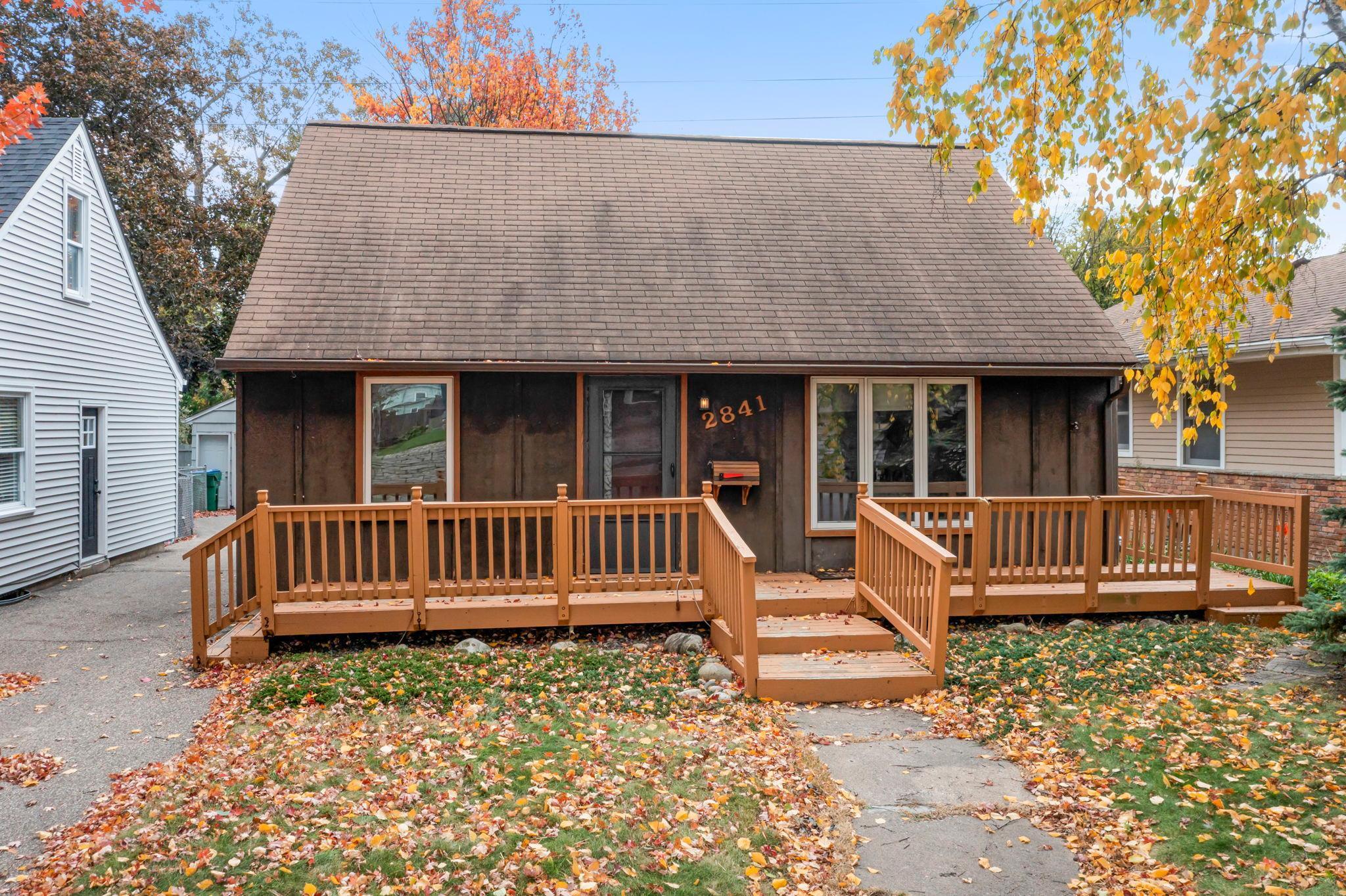 Welcome to this charming 3-bedroom, 2-bathroom home, full of potential and ready for your personal touch. Nestled in a quiet St. Louis Park neighborhood, it’s within walking distance of Dakota and Birchwood Parks, and close to walking and biking trails. Enjoy the convenience of being just a short drive from numerous dining and shopping options, including The Shops at West End—one of the area’s premier destinations for entertainment and retail. The kitchen offers ample white cabinetry, durable vinyl flooring, and convenient access to the inviting three-season porch—complete with vaulted ceilings, a cozy wood-burning fireplace, ceiling fan, and walkout access to the spacious backyard deck. The main-level living room features original hardwood floors and large windows that flood the space with natural light. It also serves as the home’s main entry point, accessible from a spacious 32x6 front deck—perfect for relaxing or welcoming guests. The main level includes two similarly sized bedrooms, each offering ample closet space, ceiling fans, and beautiful hardwood flooring. Both rooms are conveniently located just steps from the main floor’s updated 3/4 bathroom, which features a walk-in shower with tile surround and stylish black finishes. Upstairs, you'll find a spacious primary bedroom featuring a combination of hardwood flooring and carpet, along with abundant closet and storage space to accommodate all your wardrobe needs. The lower level features a spacious family room with carpeting and closet space. Adjacent to the family room is a convenient 3/4 bathroom and a dedicated laundry area. Completing the lower level is a partially finished workshop with built-in cabinetry and counter space, ideal for hobbies, crafts, or extra storage. This home also features a detached one-stall garage and a partially fenced backyard. Several updates have been made to the home, including fresh paint, new carpet in the three-season porch, and new deck stairs and a privacy fence. Don’t miss the opportunity to own a property with many updates and potential, ready for your personal touch, and located in a fantastic area!