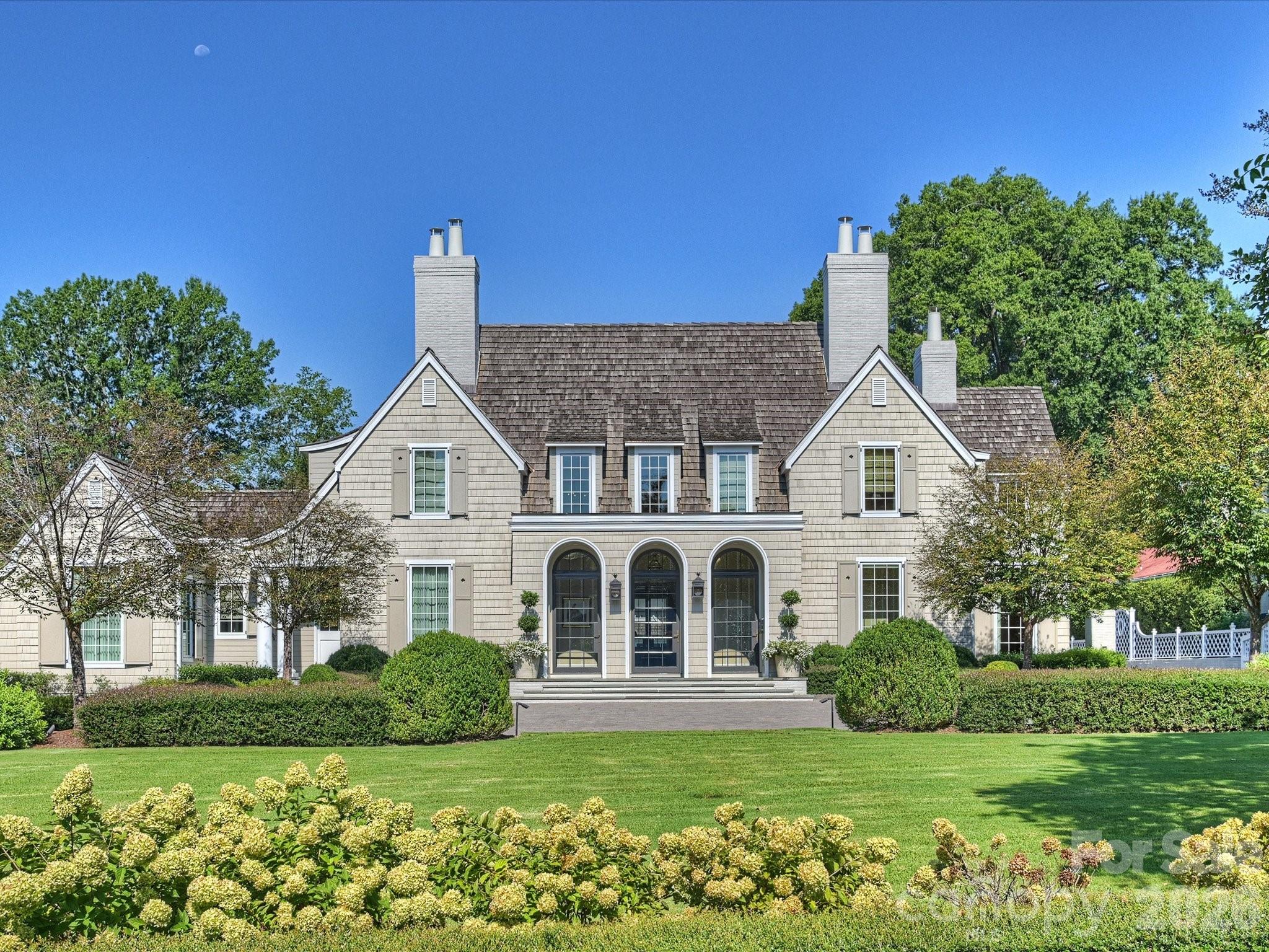 Exceptional custom estate crafted by renowned builder Ted Thompson, with architecture by Garrett Nelson. This extraordinary residence blends timeless architecture, impeccable craftsmanship, and sophisticated functionality.  Every element has been thoughtfully conceived to create a residence that is as functional as it is beautiful—equally suited for grand-scale entertaining and gracious everyday living.  Highlights include a main floor private primary wing with garden views, fireplace terrace, morning kitchen, custom dressing rooms, and luxurious marble bath with steam shower, dual vanities and soaking tub. A main floor guest suite offers maximum flexibility with a dedicated exterior door and a morning kitchen.  The chef's kitchen features an oversized marble island, premium appliances, custom storage, walk-in pantry, keeping room, and fully equipped caterer's kitchen.  Additional features include three en-suite bedrooms, office/library, den, upper-level lounge with wet bar, a lower-level fitness room, climate-controlled wine room, elevator, and whole-house lighting controls.  A mudroom with back door entrance, oversized custom locker closets, a dog room with built-in kennels and a sink create an organized space for day to day living out of sight of the primary living spaces. Resort-style grounds feature a saltwater pool, spa, expansive terraces, outdoor fireplace, retractable awning, grilling station, putting green, basketball goal, kitchen garden, and beautifully curated landscaping. The pool pavilion offers a sauna, wet bar, Sub-Zero refrigeration, full bath, gas fireplace, and disappearing Nano doors. Detached garage with custom storage, EV charging, and guest parking complete this remarkable estate.  Welcome home to Forest Drive!