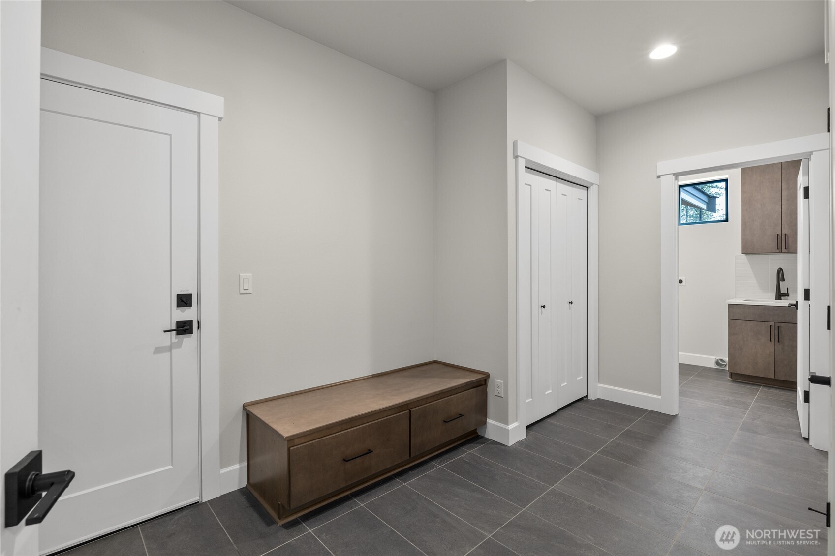 Large laundry room with utility sink.