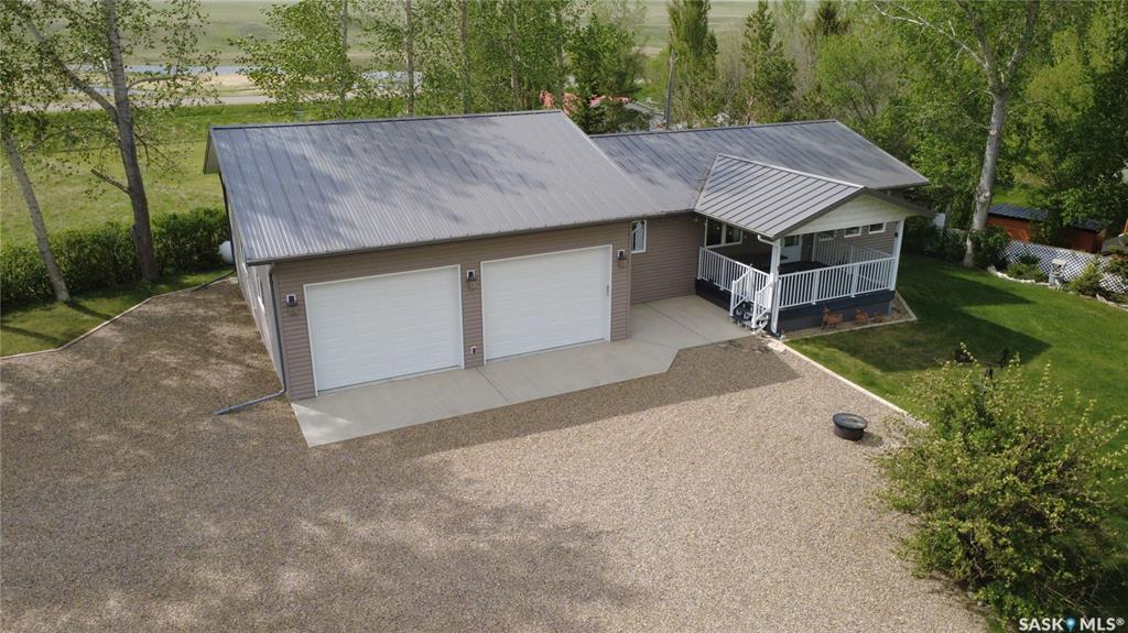 If lake life is calling but you still want the comfort of a solid, well-planned home, this Carefree Park property delivers in all the right ways. Just a 45-minute drive from Swift Current, #2 Fisherman’s Drive offers a relaxed resort setting with room to breathe and space to enjoy. The 1,176-sq.ft. home was built in 1993 and moved onto this property and a new basement in 2014 complete with weeping tile. In 2015, the 30x36 garage was added, built on 4’ piles with a 5” thick slab complete with rebar. It gives you all the space you need for a boat, water toys, and the usual lineup of lake gear, including a fish-cleaning station. Inside, the kitchen is equipped with oak cupboards and updated stainless-steel appliances, and flows naturally into the dining area. The living room view captures wide prairie views to the east, with easy access to the covered deck for morning coffee or winding down in the evening, adding a sense of openness that’s hard to replicate. On the main floor, you’ll find three bedrooms, a full bath, and laundry all conveniently located, while the lower level offers a huge fourth bedroom, a three-piece bath, and a generous rec space. Set on a large, partially fenced lot with mature trees, the property also features plenty of parking for RVs or company. A reliable 50’ well with 30” cribbing was drilled around 2008 and had a 13 gal./min. flow at that time. The septic system is a single-chamber 2,000-gal. fiberglass tank that was installed in 2015. Extras include central vac, a reverse osmosis water treatment system, a high-efficiency propane furnace, PVC windows, vinyl siding with added insulation underneath, a metal roof, and joint ownership in a dock! Lake days, prairie sunsets, and room for every toy you own… this is the kind of place people talk about owning someday but rarely get the chance to make it happen. Don’t let it slip past you.
