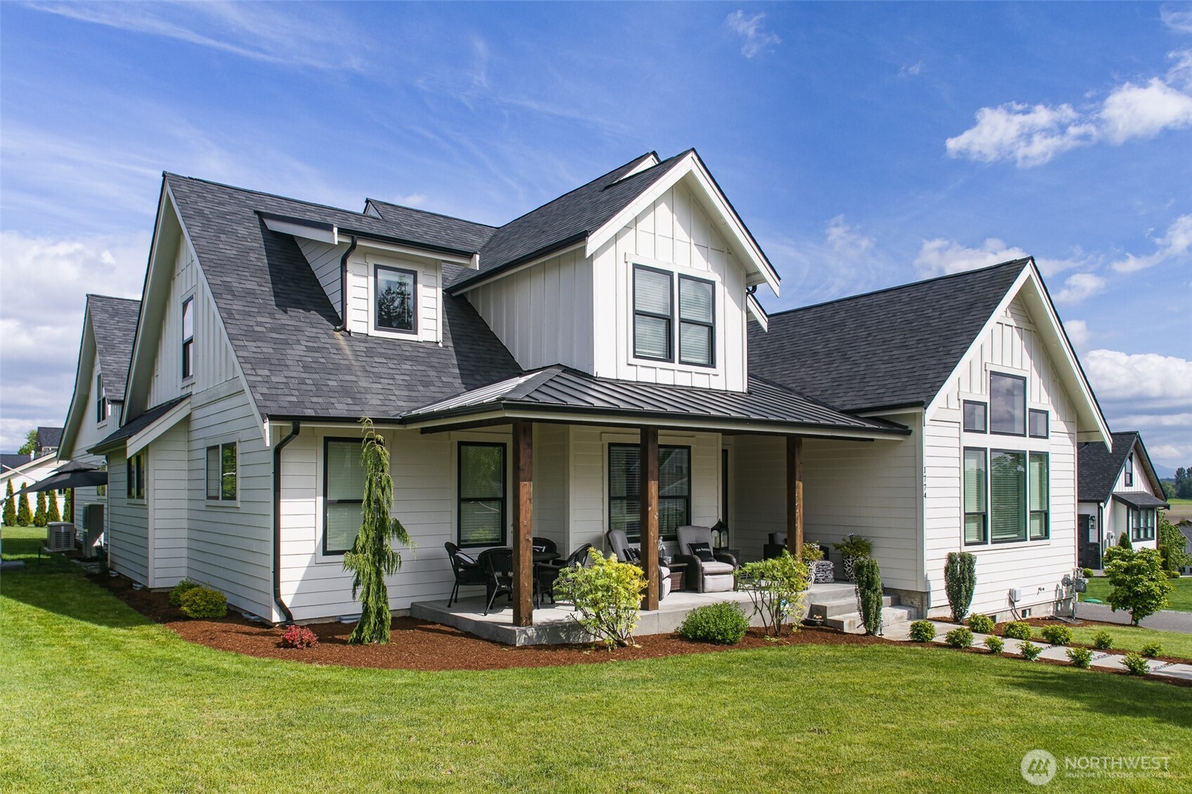 This 3,567 sq ft home sits on nearly half an acre and offers 5 bedrooms, 5 bathrooms, and a den—including private 1-bed/1-bath ADU with full kitchen and laundry, ideal for rental income or multi-generational living. The main home features a chef’s kitchen with quartz countertops and Café appliances, vaulted ceilings, a gas fireplace, smart lighting, and Ring security. Retreat to the luxurious primary suite and enjoy peace of mind with a Kohler whole-home generator with automatic transfer switch. Outdoor living shines with two covered porches, while the 3-car garage includes an EV charger. Plenty of room to add a pool or workshop. Walk to the Fairgrounds and enjoy quick access to shopping, dining, and the Canadian border.