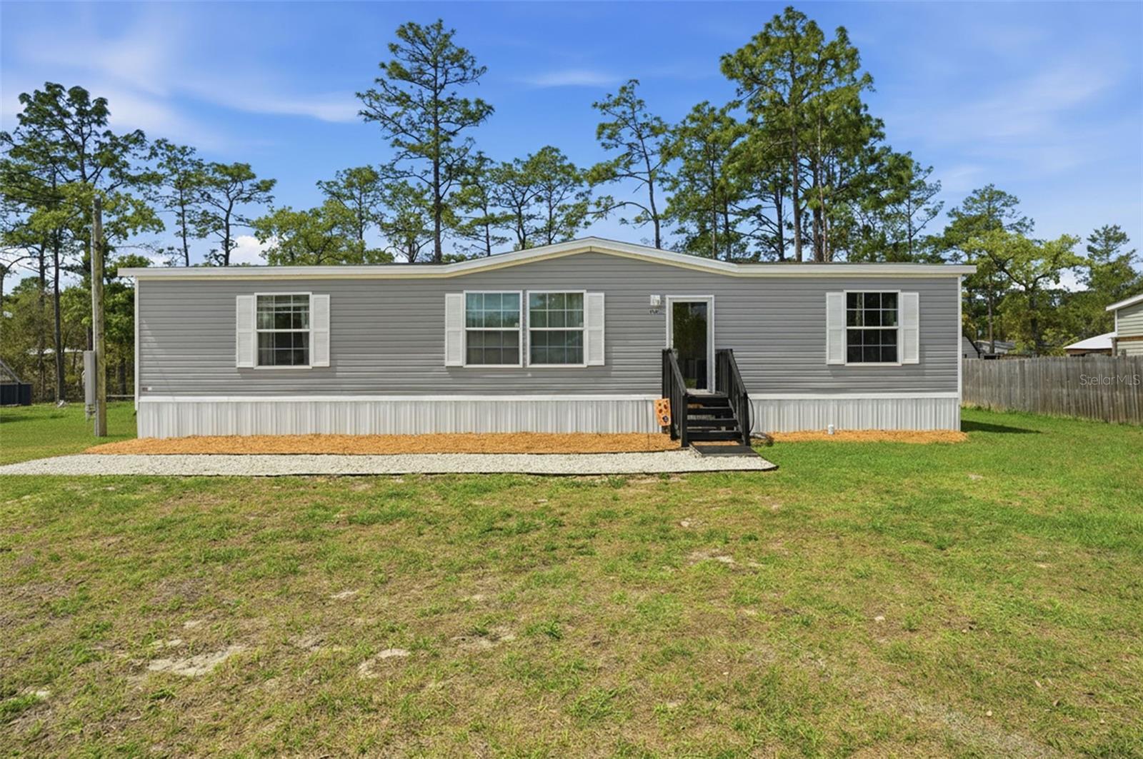 Welcome home to this adorable and affordable gem in the heart of Citrus County! Built in 2022, this well-loved 3-bedroom, 2-bathroom home offers modern comfort with thoughtful features throughout. Step inside to find fresh paint and durable vinyl flooring flowing seamlessly through the entire home. The split floor plan provides privacy, with a spacious primary suite featuring a large bedroom, an oversized walk-in closet, and a beautifully designed walk-in shower. The two guest bedrooms are generously sized, each with their own walk-in closets--perfect for family, guests, or a home office setup. The large laundry room adds convenience and includes direct access to the backyard. Outside, you'll love the great-sized lot with a rocked driveway and walkway, plus a spacious backyard shaded by mature trees--ideal for relaxing, entertaining, or future additions. Situated high and dry and not in a flood zone, this home offers peace of mind along with charm and value. Move-in ready and waiting for its new owners-don't miss this opportunity!