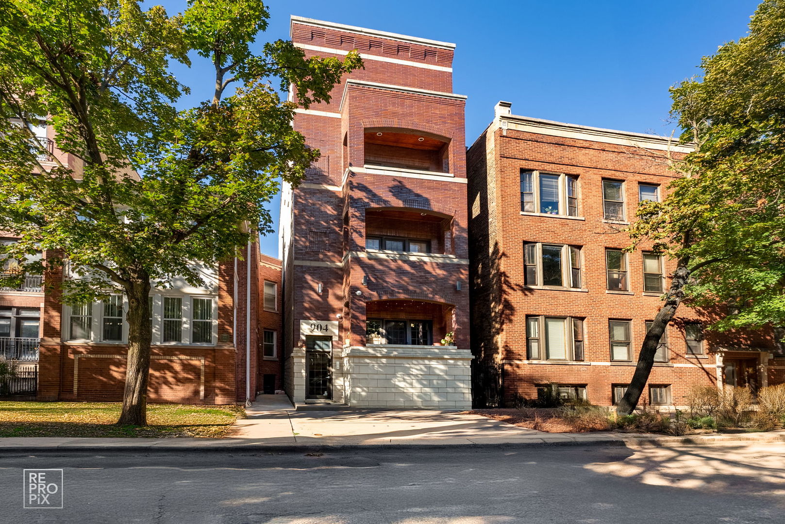 Located on a picturesque tree-lined street, this timeless brick building-completed in 2005 with thoughtful attention to detail-combines classic craftsmanship with modern comfort.    Step inside to a spacious living room featuring a gas-start wood-burning fireplace with a marble surround and custom mantle, creating a warm and inviting focal point. The adjoining balcony overlooks mature trees, offering a serene spot to unwind or entertain.    The open-concept kitchen is fully upgraded with stainless steel appliances, granite countertops, an abundance of custom cabinetry, and a spacious pantry for additional storage. A breakfast bar opens to the living area, providing an ideal layout for everyday living and hosting.    The primary suite is a true retreat, featuring a private balcony, excellent closet space, and a spa-inspired bath with a double vanity, jetted tub with body sprays, and a second vanity with extra storage. The second bedroom is generously sized with a walk-in closet, and the second full bath offers luxurious finishes and a steam shower with multiple body sprays.    Elegant finishes continue throughout the home, including Brazilian Cherrywood floors with inlay, solid-core wood doors, surround sound wiring, and custom millwork with crown molding. The thoughtful floor plan provides exceptional interior storage, a full-size laundry area with a large utility sink, and an overall sense of warmth and quality that's hard to find.    This well-maintained, self-managed boutique building is known for its quality construction and quiet, residential feel. Assessments remain low, and the property is pet-friendly. One exterior parking space is included.    Enjoy an unbeatable Lakeview location close to the Southport Corridor, Wrigley Field, and the lakefront, with easy access to the Brown, Purple, and Red Line trains, plus countless restaurants, cafes, and neighborhood boutiques all within a short walk.