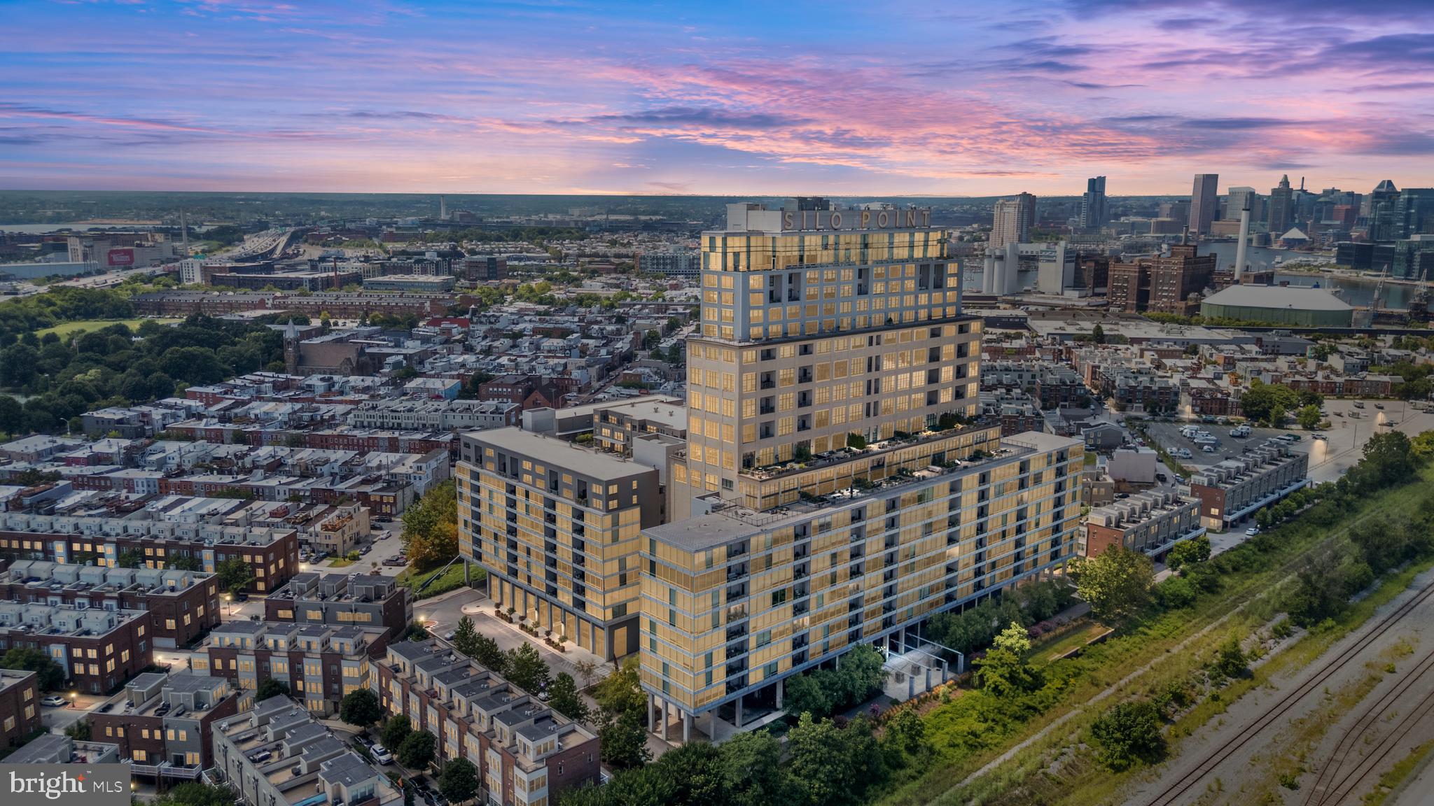 Experience low-maintenance waterfront living in the heart of Locust Point. This light-filled residence offers serene, panoramic water views and an open layout featuring hardwood flooring, a chef-inspired kitchen with granite countertops, and generous storage throughout. The spacious bedroom includes a large walk-in closet and a spa-like bath, while a separate in-unit laundry area adds everyday convenience. A private balcony extends the living space outdoors, providing the perfect setting for entertaining or simply enjoying the tranquil waterfront backdrop. Additional highlights include two reserved parking spaces in the secure resident garage, along with building amenities such as a 24-hour front desk, a state-of-the-art fitness center, yoga studio, game and conference room, bike storage, and access to the 19th-floor Sky Lounge with remarkable fireworks views. All of this is set within historic Locust Point, offering exceptional proximity to Fort McHenry, Baltimore Peninsula, waterfront parks, neighborhood shops and dining, water taxi stops, major highways, and BWI Airport. Don’t miss this opportunity to enjoy natural light, water views, and effortless living in one of Baltimore’s most coveted neighborhoods.