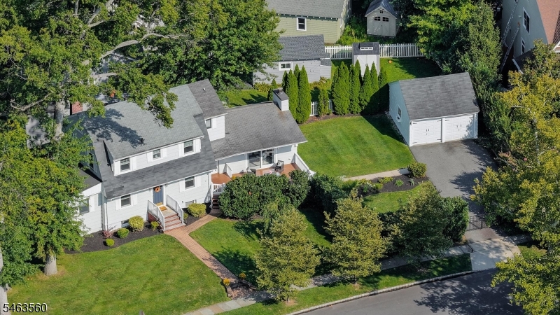 Welcome Home to this Beautiful 4Bed, 3.1Bath Center Hall Colonial, Ideally Situated on a Quiet, Tree-Lined Street in Desirable Westfield, Walk to NJ Train to NYC. Bright, Charming & Move-in Ready, this Home Offers Generous Living Space & a Wonderful Flow Throughout. Step Into the Welcoming Foyer, on Your Left is the Spacious LR w/Built-ins, Fireplace & New Crown Molding, Opening to a Bright Home Office w/Plenty of Natural Light. On Your Right is the Formal Dining Room w/Access to the Front Deck, Perfect for Outdoor Dining & Entertaining. Moving Forward is the Spacious Updated Eat-in Kitchen w/New Quartz Countertops, Open to the Large Family Room w/Fireplace & Access to the Front Deck, Creating an Easy Flow for Everyday Living & Gatherings. A Convenient Powder Room Completes this Level. 2nd Flr Offers 4 Bedrooms & 2 Full Baths, Including a Large Primary Bedroom Suite w/Updated Primary Bath & New Quartz Countertop. The Walk-up 3rd Flr Attic Offers Plenty of Storage Space. The Partially Finished Walk-out Basement Adds Flexible Living Space w/a Full Bath & Additional Home Office/Rec Room. Outside, Enjoy the Fully Fenced Side Yard w/Beautifully Maintained Lawn & Shrubs, Plus a 2-Car Detached Garage. Convenient to Schools, NYC Transportation, Shopping, Dining & Vibrant Downtown Westfield. Notable Updates Include New Steam Boiler (2021), Range Hood (2023), Kitchen & Primary Bath Quartz Countertops (2025), Split A/C in Family Room (2025) & Crown Molding in LR, DR & 2 Bedrooms (2026).