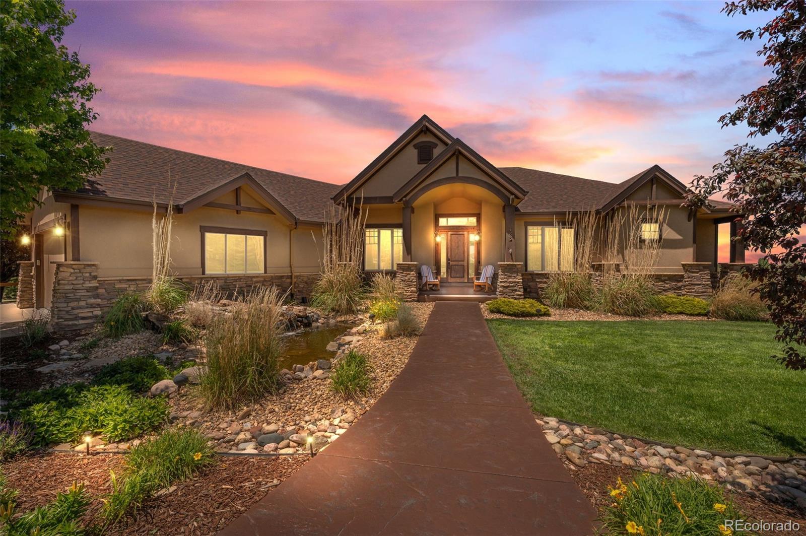 Quintessential Colorado living in the coveted Sky Rim neighborhood. Nestled on five private acres, this meticulously maintained ranch-style home showcases exceptional pride of ownership and breathtaking outdoor living. A welcoming water feature sets the tone as you arrive at this remarkable property.Inside, the sun-filled main level offers an open-concept design perfect for everyday living and entertaining. The gourmet kitchen features two spacious islands, stainless steel appliances, abundant cabinetry, and a pantry. Adjacent to the kitchen are a charming breakfast nook and an expansive family room anchored by a stunning stone fireplace. A formal dining room and private office with French doors provide both elegance and functionality. The luxurious primary suite serves as a private retreat with direct access to the deck, a beautifully remodeled spa-inspired bath featuring a soaking tub, and generous walk-in closet space. The walkout lower level is designed for entertaining and relaxation, offering a spacious great room with a fireplace, pool table area, and a fully equipped wet bar complete with a refrigerator, microwave, and dishwasher. This level also includes a large guest bedroom, a three-quarter bath, an oversized exercise or theater room, and extensive storage running the entire length of the home. Outdoor living is equally impressive. Enjoy Colorado's stunning scenery from the expansive Trex deck or the covered patio featuring a newer hot tub and outdoor fireplace. A paved circular driveway provides easy access to both the main residence and a separate finished oversized three-car garage, complete with water service and gas-line readiness for future customization. This exceptional property combines privacy, luxury, and the very best of Colorado living.