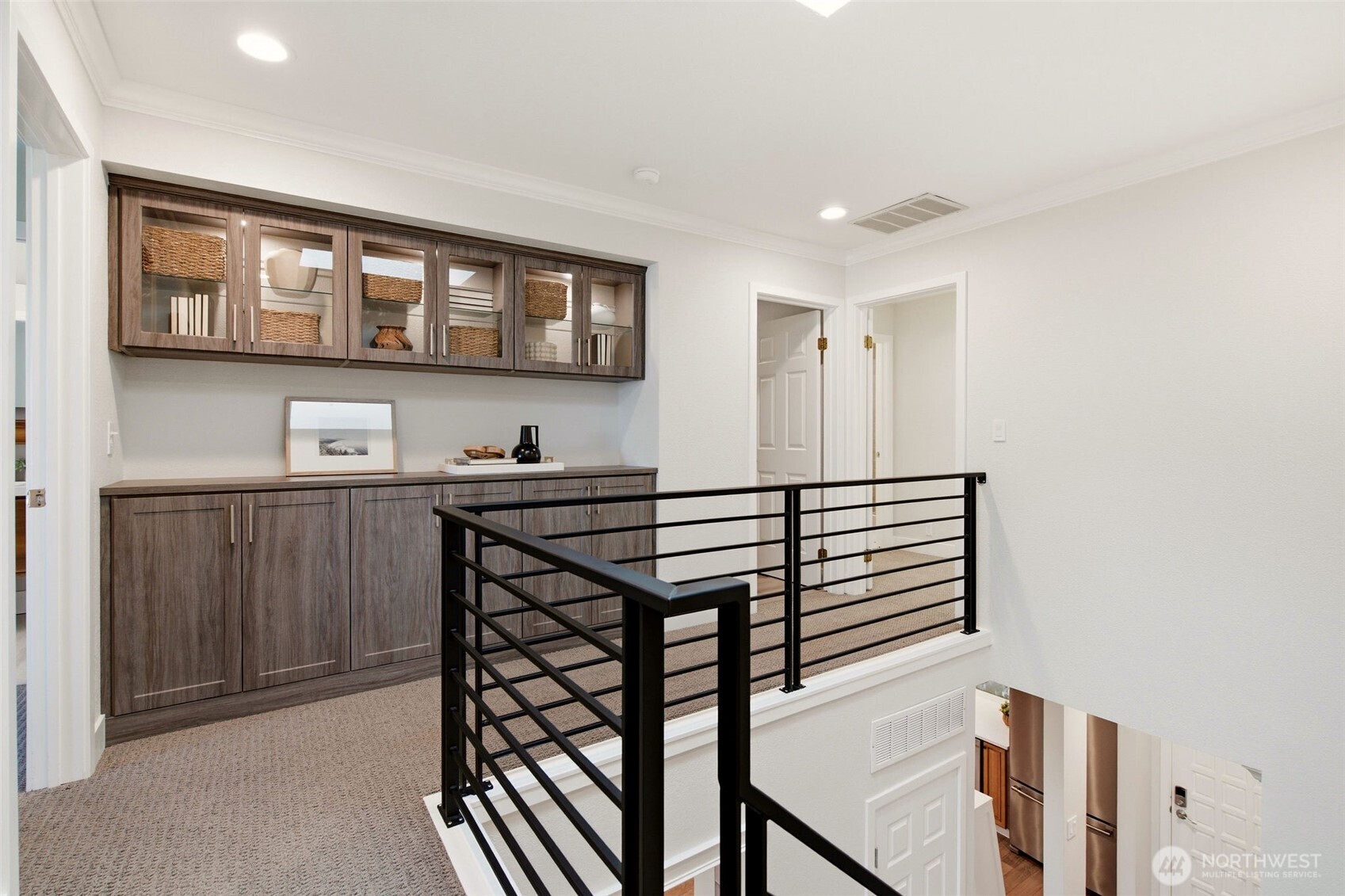 unctional upper landing with built-in storage and contemporary railing details.