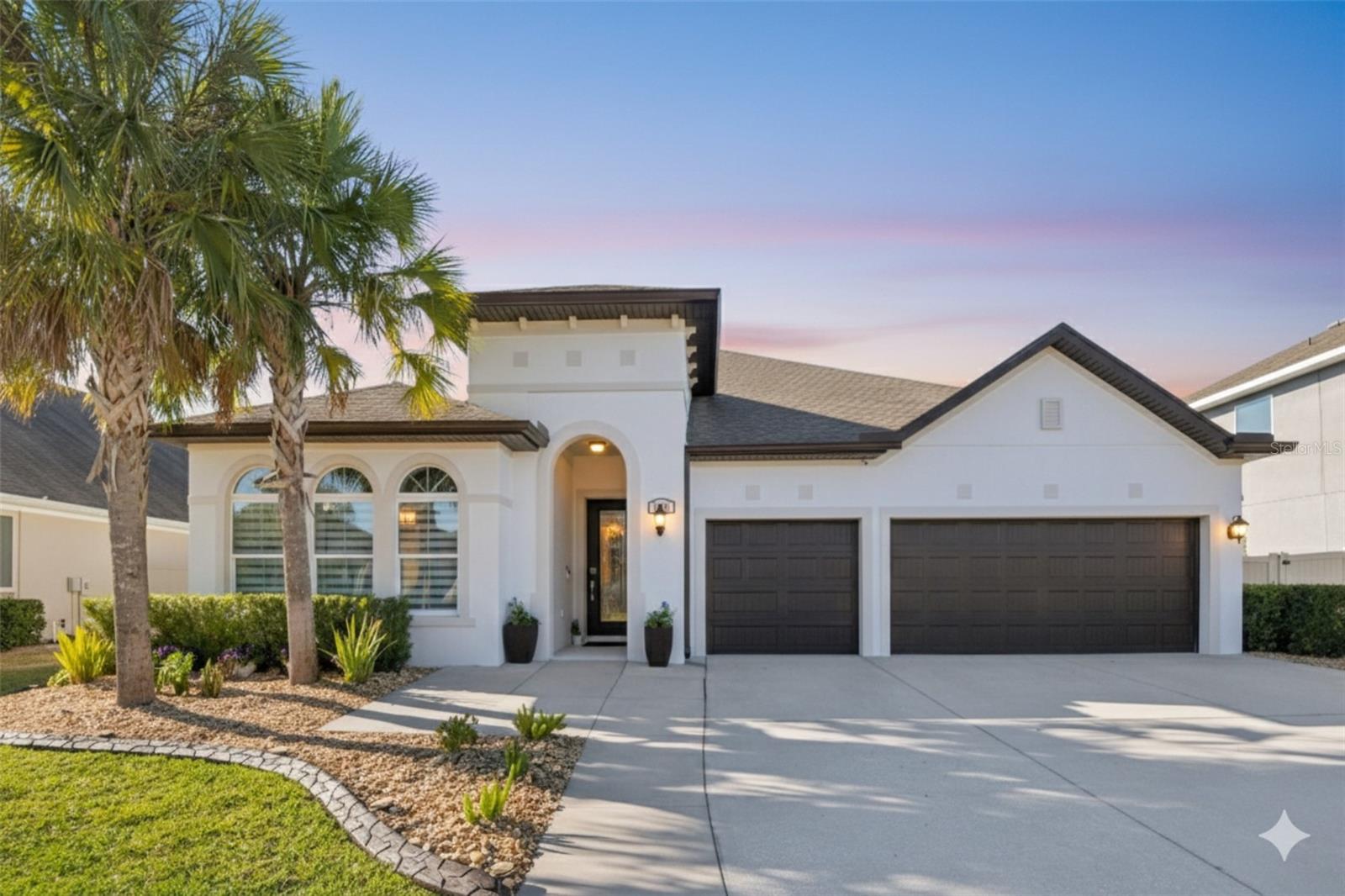 Experience the pinnacle of Wesley Chapel living in this masterfully crafted home, where architectural elegance meets modern, high-performance luxury. From the moment you enter through the custom glass-door entryway, you are greeted by soaring ceilings, sophisticated millwork, and new modern light fixtures in the kitchen, dining, and living rooms that illuminate a spacious floor plan.The interior is freshly updated for 2025, featuring new paint throughout and premium laminate flooring across all bedrooms, the stairwell, and the expansive loft. The heart of the home is a chef’s dream, recently reimagined with premium quartz countertops, a custom hood, and a newly integrated custom wine closet for the discerning collector. Practical luxury extends to every corner, including a reverse osmosis water filtration system and new blinds in the home office and all four bedrooms.For the entertainer, the home features a built-in surround sound speaker system in both the great room and on the patio. Step through the sliders into your private outdoor sanctuary, boasting a tiled, heated pool and spa, a built-in outdoor kitchen, and a fully fenced yard designed for seamless entertaining.  The 3-car garage features an installed generator inlet box, professionally installed Epoxy Flooring (2025), and a ton of storage with overhead custom racks throughout.Beyond the home’s meticulous mechanical upgrades—including a whole-home surge protector and a freshly painted exterior (2024)—residents of Union Park enjoy an unparalleled lifestyle. This home truly has it all; schedule your private tour today and don’t miss the chance to make this exceptional property yours!