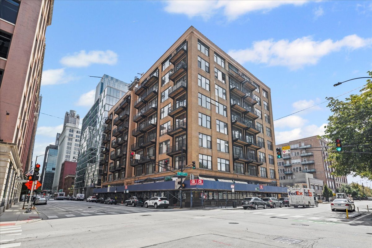 Welcome to this sun-filled corner loft in a boutique elevator building located in the heart of the West Loop. This 2 bed/2 bath unit blends industrial charm with modern finishes and features high timber ceilings, exposed brick, and hardwood floors throughout. As you enter, you are greeted with a beautiful, sleek kitchen open to the living area with a large island, stainless steel appliances, and a gas fireplace. Spacious living room is surrounded by oversized, south-west facing windows and gives you access to a private balcony. The primary bedroom features a walk-in closet with an additional organized closet and a modern en suite bathroom with double vanity and a soaking tub. The second bedroom has a beautiful built-in shelving and great lighting while second bathroom features a walk-in shower and a natural limestone tile. Additional highlights include ample closet space, in-unit Washer/Dryer and a parking space included in the price. Building amenities include a fitness center, convenience store, extra storage and bike room. Perfect location close to the Loop, Union station, Greektown, Fulton market and expressways.