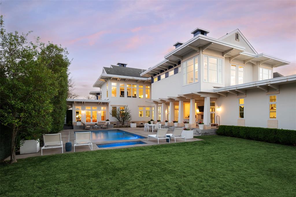 This innovative interpretation of the classic Craftsman home at 6215 Norway carries an air of the resort lifestyle of the Hamptons or Seaside, Florida. Chosen for the AIA Dallas Home Tour in 2023, it is one of only a handful of homes with a private access gate to the St. Mark’s campus. The convenience and privacy this location offers are truly exceptional. Designed by architect Michael Malone and built by Manning Snelling, the 6,886 square foot, 5 bedroom, 6.1 bathroom residence is set on an extra-deep 100 x 200 lot. Malone drew inspiration from C.F.A. Voysey, and Frank Lloyd Wright to create this timeless look. Thick tapered columns, and the large gabled front porch, create an immediate sense of invitation. A blue frieze line of tile at the top of the offers a memorable design element. An environmentally sound home, each major interior space has a corresponding exterior area, allowing for a continuous flow of light. A uniform set of finishes, including Carrera marble and white oak floors, is used throughout the house. Traditional and modern elements are beautifully balanced. Classic open living and dining rooms offer a unique twist, a grid pattern as a unifying design motif. The decorative grid paneling continues in the two-story family room, where a butler’s pantry and a wine room are tucked behind the open-plan kitchen. The primary wing ceiling extends the grid pattern in a streamlined industrial touch, with French doors opening to the pool. The principal bathroom is wrapped in marble with a large shower and a vessel tub. Upstairs are four generously sized ensuite bedrooms – two that offer incredible panoramic views onto St. Mark’s campus.  A playroom and exercise room complete the upstairs. With 1,200 square feet of outdoor living space, featuring a covered patio with a fireplace and grill station, a large grassy area, and a pool and spa, this is an ideal environment for both daily living and entertaining. A 3-car garage with room for lifts completes the home.