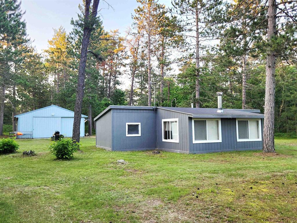 CABIN WITH 60.5 ACRES WITH STATE LAND ON 2 SIDES. POLE BARN 30 x 40 with electric. Recreational cabin with 1 bedroom, 1 bath offers open kitchen, dining and living area plus a family room with a walkout patio door. L.P. Gas Payne Wall Furnace and a wood stove in the Family Room. Campfire pit in front yard. Hunters take delight in the trails throughout the property and 6-7 deer blinds, 1 tree stand and a ground blind. 3 new vinyl windows in the Family Room. Seller has a new mini split they are planning on installing. Snowmobile and ATV trails closeby. Close to I-27 and I-75 for easy access and 10 minutes from Grayling downtown.