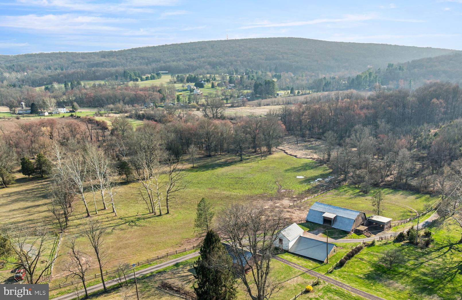 Bring the horses​- this is the kind of property they’ve been waiting for​!Tucked away on a private lane in beautiful Chester County, this 11+ acre parcel offers a rare blend of privacy, natural beauty, and true equestrian functionality. Designed with horse lovers in mind, the property is already well-equipped and ready to support a variety of uses, from a private riding retreat to a small-scale farmette. At the heart of the property is a substantial 45x55 stone bank barn featuring 12 standard stalls, 1 broodmare stall with private paddock, tack room, blanket room, and generous upper-level storage for hay, feed, and equipment. Rebuilt in the 70's, the barn has higher than normal headroom for a barn of the 1700's and at times housed 17 hand horses. The barn opens directly to fenced pasture, creating an easy, efficient setup for daily care and turnout. Additional outbuildings include a spacious carport for vehicles or farm equipment, and a stone pony barn with a 28x45 enclosed space and​ large attached open storage area with floored upper-level, both with new metals roofs. If you have ever wanted to live in a converted barn, talk about potential! The land itself is equally impressive, offering a mix of open pasture, mature woods, gently rolling terrain, and a peaceful stream that winds through the property. Whether you’re riding, grazing, or simply enjoying the views, the setting delivers both function and beauty in equal measure.And the location only adds to the appeal - Chester County is widely known for its deep-rooted equestrian culture, with a strong community of horse owners, trainers, and professionals. Whether your interests include fox hunting, trail riding, eventing, dressage, polo, or steeplechasing, you’ll find endless opportunities nearby. With an abundance of preserved land, riding trails, and top-tier facilities - along with easy access to specialized equine veterinary care - this is a setting where both you and your horses can truly thrive.This property is not subdividable and is enrolled in Act 319, providing favorable tax benefits. Buyers are encouraged to perform due diligence regarding zoning, easements, and permitted uses. Just minutes from Rt 100, 422, and the PA turnpike. Bring your own builder and architect to create a custom home that complements this exceptional setting and supports the lifestyle you’ve been looking for.