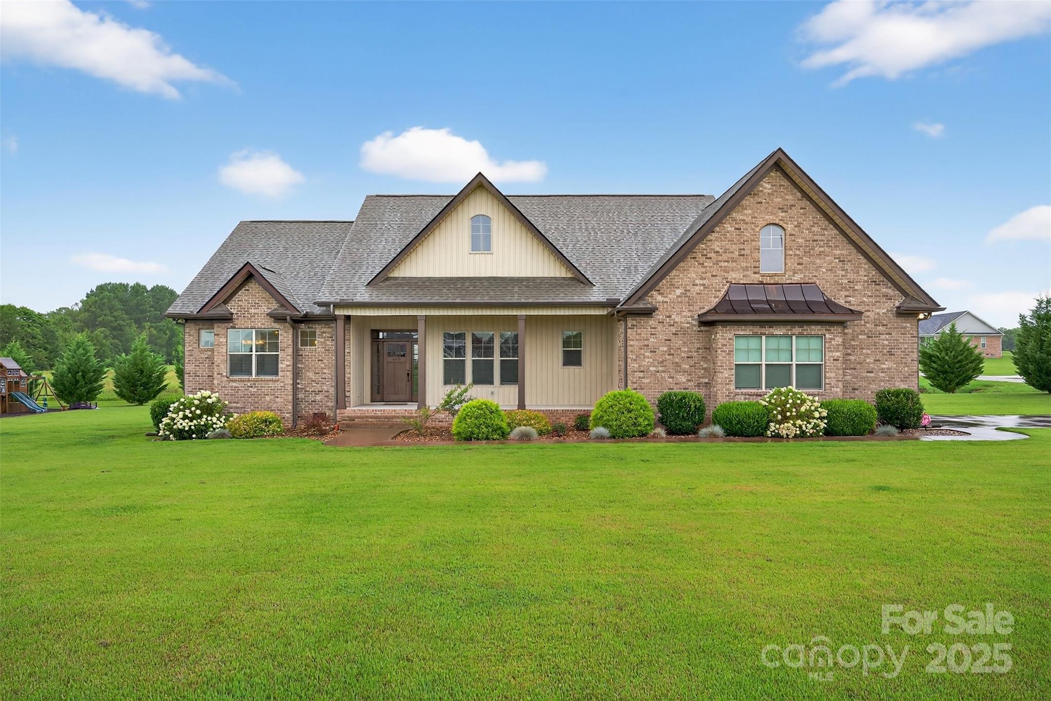 Beautiful 3-bedroom, 3-full bath home with versatile flex space, situated on a spacious 1-acre lot in Cowpens. This property is filled with custom features including ¾-inch hardwood floors, a rocked gas fireplace, copper roof accents, custom cabinetry, granite countertops,ceramic tile, and vaulted/tray ceilings throughout. The open kitchen includes a walk-in pantry and flows into a large laundry room with a utility sink for added convenience. Step outside to enjoy a covered back porch, saltwater pool, and playground—perfect for entertaining,relaxing, or family fun. The master suite features tray ceilings with crown molding and cove lighting, two oversized walk-in closets, a garden tub, a custom tiled shower, and double vanities. Bedroom 2 also boasts a large walk-in closet, and there are four additional storage closets throughout the home. A flexible room—complete with a nearby full bathroom and closet—offers endless possibilities: a fourth bedroom, guest suite, or private home office. All major appliances (washer, dryer, refrigerator, stove, microwave, and dishwasher)will remain with an acceptable offer, making this home truly move-in ready. The level backyard is ideal for kids, pets, and outdoor fun—from running and playing to relaxing by the pool. It’s also perfect for gardening or future outdoor living projects. Located in a quiet area near I-85, between Spartanburg and Gaffney, this home offers space, privacy, and convenience.