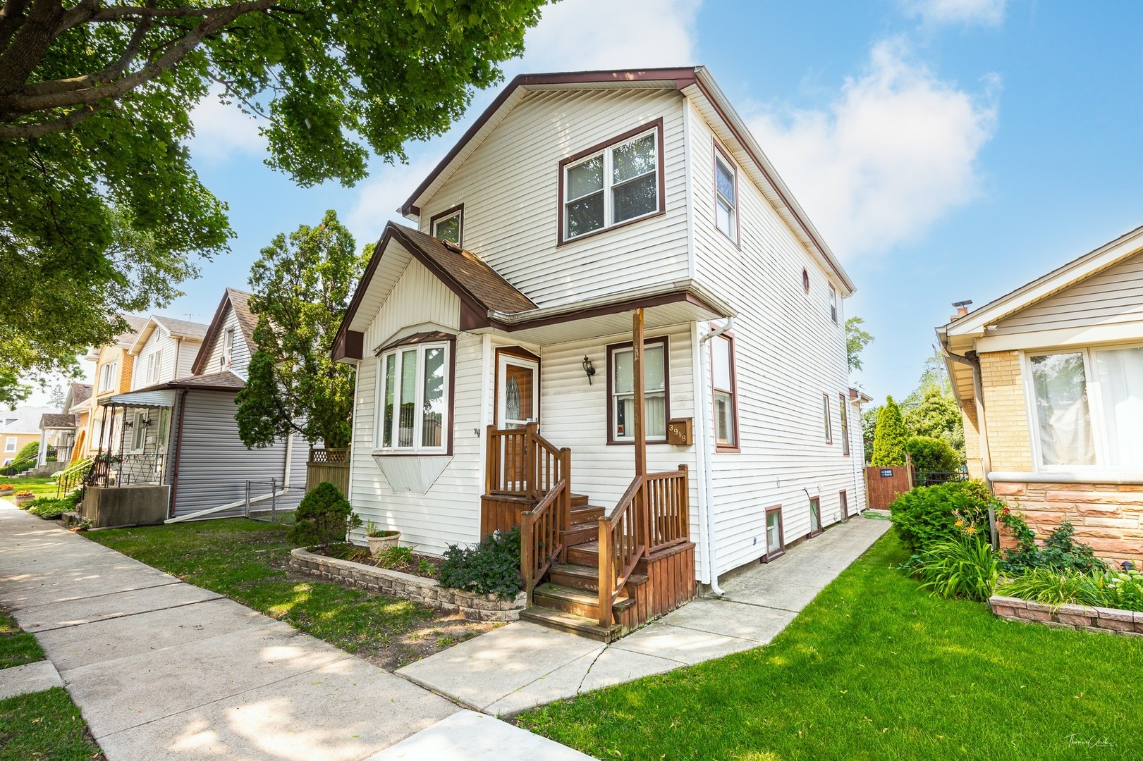 This is a lovingly maintained classic home nestled in the vibrant Dunning neighborhood of Chicago. This spacious residence features a warm and inviting main level with exposed wood-beam ceilings, a cozy gas fireplace, and a generous living room perfect for relaxing or entertaining. The oversized eat-in kitchen boasts an abundance of cabinetry, a large island with seating, and charming vintage details, opening into a bright dining area with views of the backyard. Upstairs, you'll find comfortable bedrooms with plenty of natural light, while the finished basement offers flexible living space ideal for a game room, home office, or media area. Outside, enjoy the lush fenced yard and large deck-perfect for summer gatherings. Located on a tree-lined street, this home offers easy access to parks, schools, shopping, and transportation, all within the highly desirable Dunning community.