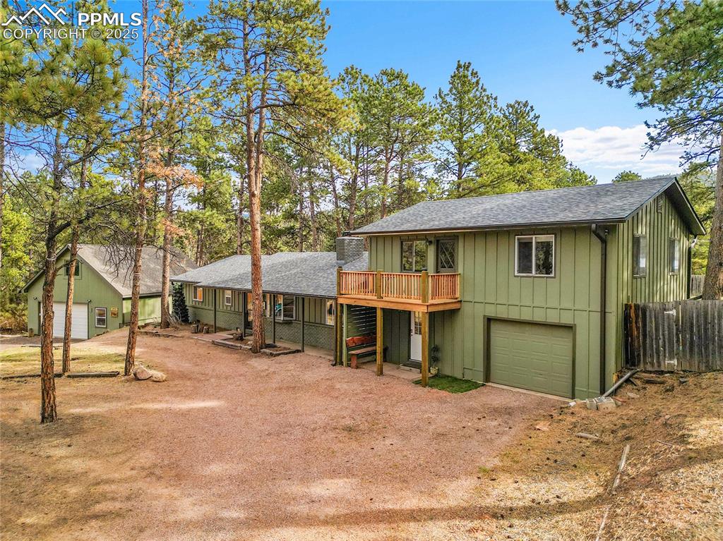 Live in one side, rent the other—or keep it all to yourself! Tucked into the towering pines of Woodland Park, this beautifully updated 4-bed, 3-bath home offers the best of Colorado mountain living—with the rare bonus of income potential. Located on a quiet wooded corner lot just minutes from downtown, this 2,600 sq ft retreat sits on 0.65 acres with mature trees, a circular drive, and parking for all your toys—including RVs. Inside, you'll find character, comfort, and thoughtful updates. The fully renovated kitchen shines with rustic-modern cabinetry, and a wide center island perfect for gathering. With a large laundry/storage/pantry space right off the kitchen. The dual living rooms each feature cozy lounge space and share a charming double-sided fireplace—ideal for snowy winter evenings The layout is ideal for flexible living or investment: one portion of the home (with its own front and back entrance) includes a living room, dining space, kitchenette, two bedrooms, and a full bath—perfect for multigenerational living, a guest suite, or potential rental opportunity. With a one-car attached garage, additional carport, and a 30x30 two-car detached garage/workshop, there’s room for every vehicle, hobby, and project. Upstairs, you'll even find a heated “man cave” above the oversized detached garage/workshop—your own escape pod. Step outside to the walkout backyard, enjoy your morning coffee on the deck off the bedrooms, or take a stroll to nearby hiking trails, local parks, or the quaint shops and restaurants of downtown Woodland Park—just minutes away. Recent updates include a brand-new roof (2025) and tankless water heater. No basement means everything is accessible, open, and ready for comfortable main-level living. Whether you're looking to settle into a serene Colorado lifestyle or invest in a home that works as hard as you do, this mountain gem delivers.