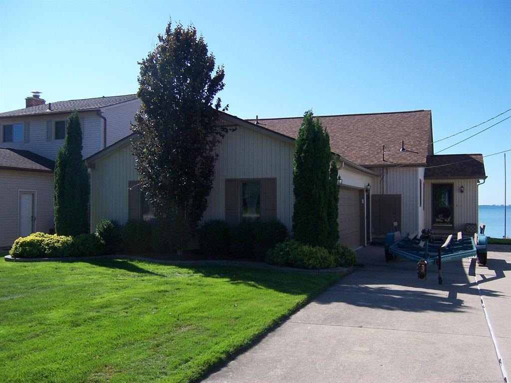 Well constructed and very well maintained lake St.Clair beauty.Clean as can be and move in ready.All bedrooms and greatroom have fabulous views of the lake.Beautiful oak floors and loads of Oak trim/stairway.1st floor master bedroom with walkin closets and full bath-2 upper beds have plenty of closet storage space and new carpet.Entryway with front and rear access doors and Oak French doors to livingroom. Large kitchen,new flooring,large pantry and lots of counter space.High efficiency furnace,c/air,and 1st floor laundry.Beautiful trex deck overlooking the lake.New retractable awning over deck.Steel seawall and boat hoist.Exterior is maintenance free.Anderson windows-oversized side entry garage with new concrete floor.Roof 3 yrs,inground sprinklers.Immediate occupancy-Good parking .
