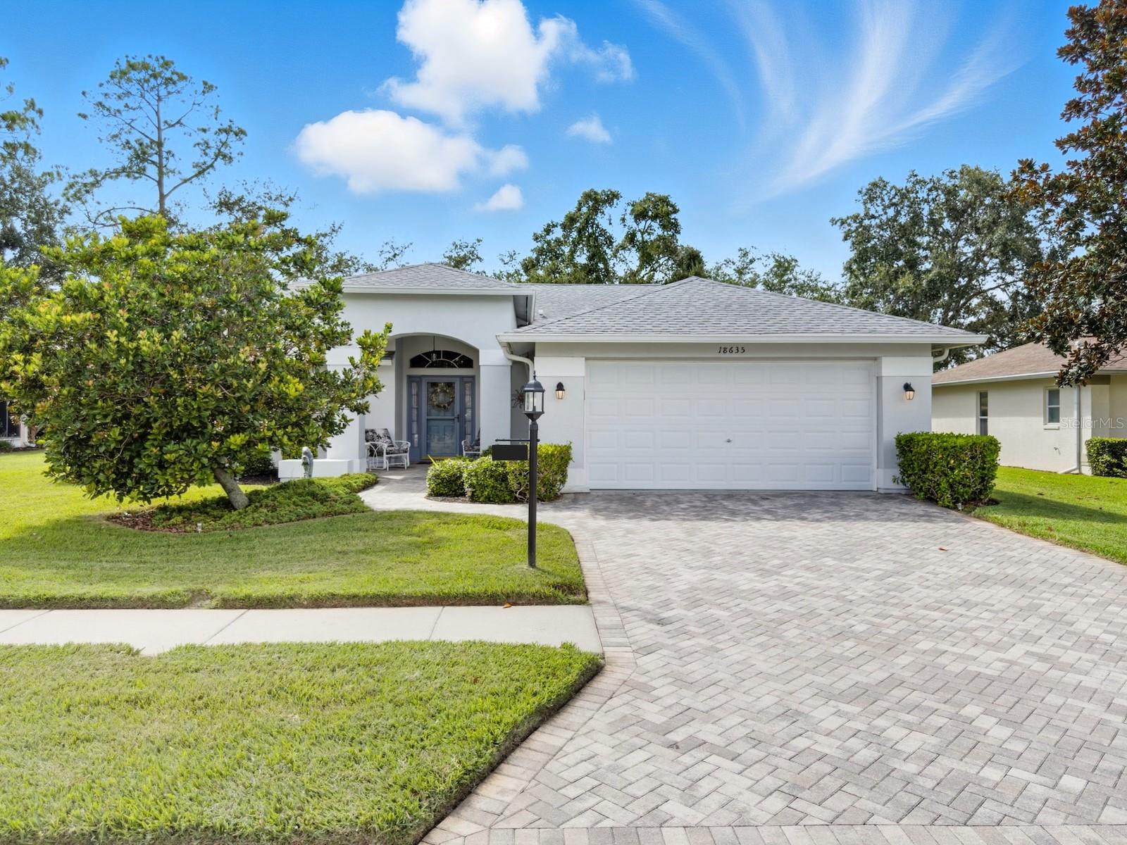Welcome to this beautifully maintained residence in the highly desirable Heritage Pines 55+ Golf Community. Offered by its original owners, this 3-bedroom, 2-bath home comes optionally turn-key—fully furnished with all contents and even a golf cart included. The paver driveway sets the tone with an inviting curb appeal. Inside, cathedral ceilings enhanced by dual solar tube lighting create a bright and spacious atmosphere. The open living and dining area flows seamlessly into the kitchen, which features a center island with breakfast bar, closet pantry, and a cozy dinette area.  The split-bedroom layout has the primary suite at the back of the home, offering dual walk-in closets and direct access to the shared Jack-and-Jill style bath with dual sinks, a walk-in shower with built-in bench, and connects to the front guest bedroom—also boasting a large walk-in closet. A third bedroom and second full bath are located on the opposite side of the home. Additional features include an indoor laundry room with cabinetry, storage closet, and washer and dryer included. Enjoy the extended enclosed lanai with paver flooring, ceiling fans, and tinted removable windows. Major updates include a newer roof (2020), AC (2015), water heater (2022), and completed, fully insurable settlement remediation (2012). Heritage Pines is a gated, amenity-rich, and pet-friendly community, featuring an 18-hole championship golf course, clubhouse with restaurant and bar, fitness center, heated pool and spa, and courts for tennis, pickleball, bocce, and more. HOA fees include cable, internet, lawn care, and irrigation, ensuring a worry-free lifestyle. Don’t miss the chance to call this home yours—explore the 3D virtual tour and schedule your private showing today!