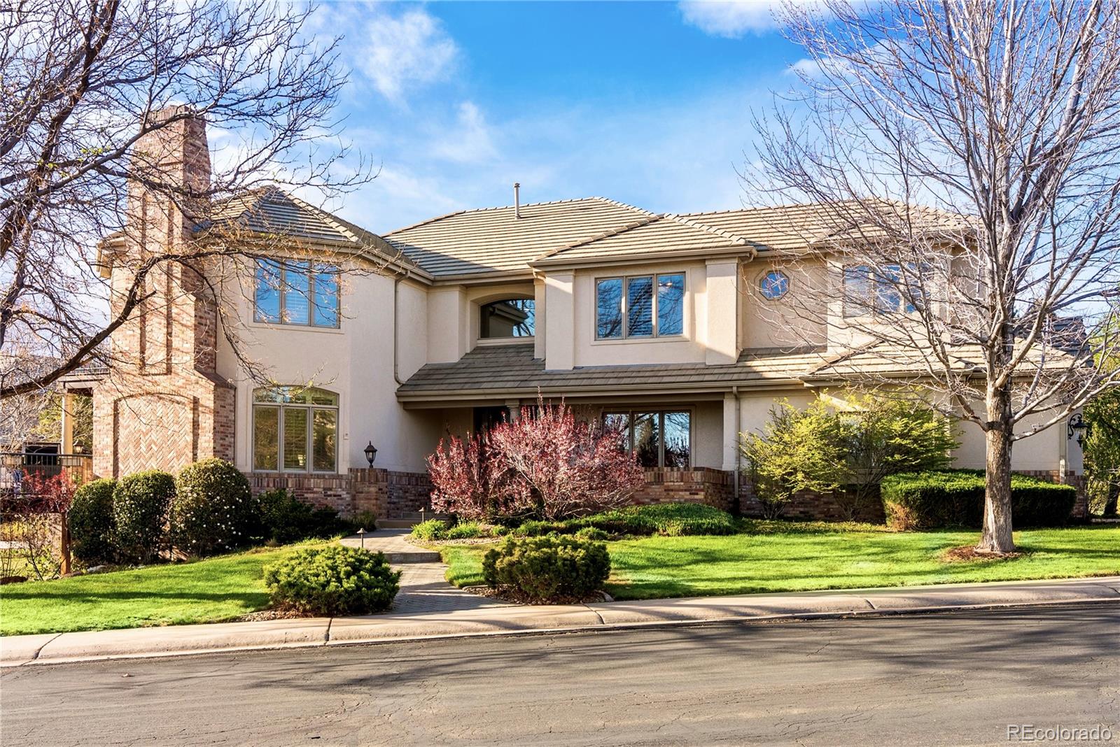 Set on a rare, half acre homesite backing to open space and the scenic High Woods Trail, this nearly 7,000-square-foot estate in the prestigious, gated Highwoods neighborhood, captures panoramic mountain views—an offering seldom available here. Mature, curated landscaping and a welcoming front patio create a sense of arrival, while proximity to the neighborhood pool, tennis, and pickleball courts enhances a true resort-style lifestyle. Inside, a grand foyer with soaring ceilings, rich cherry hardwood floors, and a curved staircase delivers a striking first impression, with expansive windows framing natural light and mountain views. A refined executive office with custom millwork and plantation shutters anchors the main level, while the formal living room features vaulted ceilings, architectural archways, floor-to-ceiling windows, and a statement gas fireplace. The chef’s kitchen blends timeless design and function with custom cherry cabinetry, granite countertops, double ovens, and a six-burner gas cooktop, opening to a sunlit breakfast nook and elevated deck positioned for sunset views. The adjacent family room offers built-ins and a second fireplace. Upstairs, the primary suite is a private retreat with its own balcony, spa-inspired five-piece bath, and expansive walk-in closet, complemented by secondary bedrooms including a private en suite, Jack-and-Jill layout, and a flexible bonus room. The walkout lower level is designed for entertaining, featuring a spacious lounge, billiards area, custom wet bar, fitness studio, private guest suite, and a spa-caliber bath with sauna and steam shower. Outdoor living is equally compelling with a slate pathway, side staircase, and wraparound deck leading to a secluded firepit lounge with Adirondack seating set against protected open space. An oversized three-car garage with epoxy floors, EV charging, and guest parking completes the home. Opportunities of this scale, setting, and privacy in Highwoods are extremely limited.