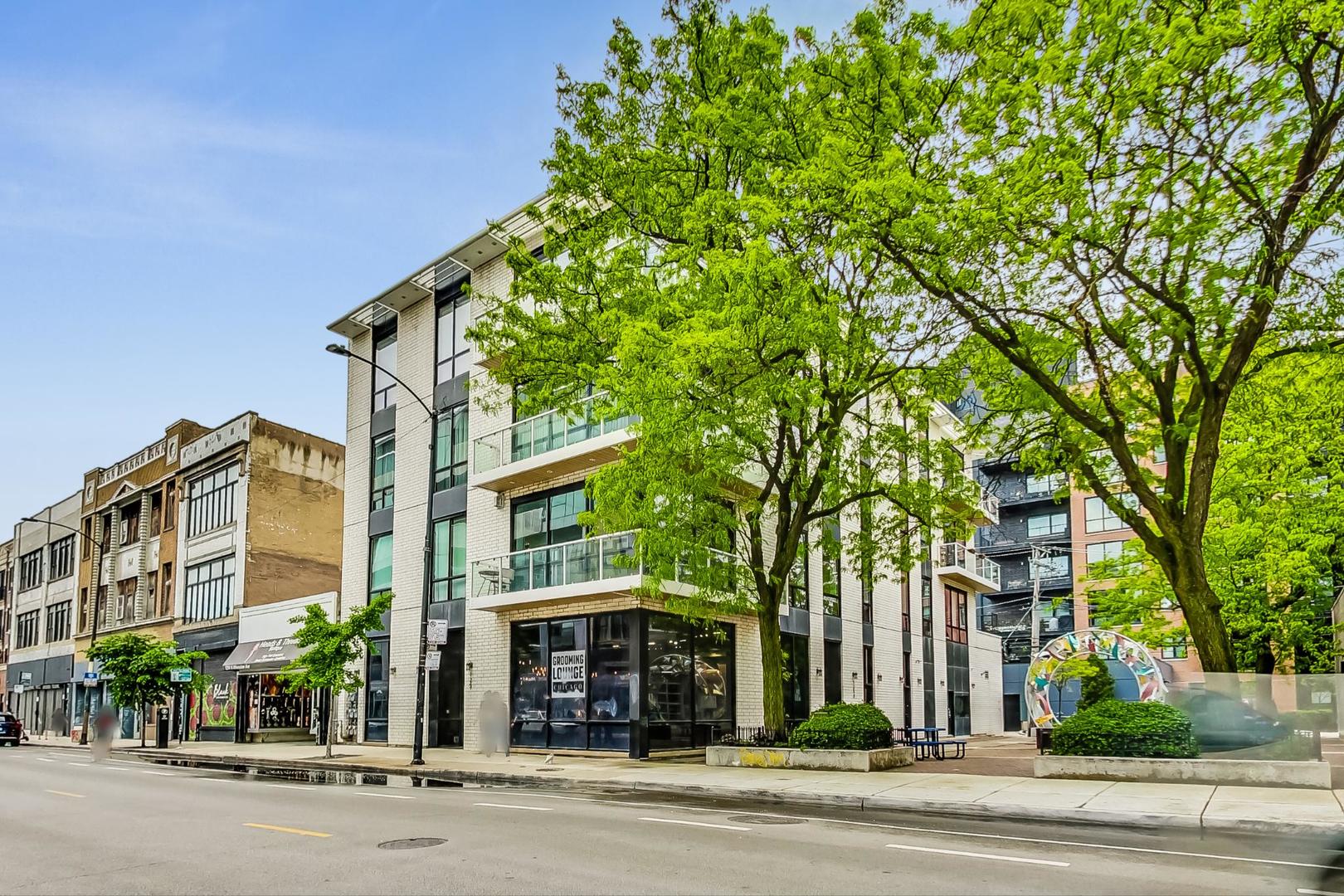 Gorgeous, sought-after luxury condo in a boutique elevator building, ideally located in the heart of Wicker Park! This rarely available, featured model corner unit offers 3 bedrooms and 2.5 baths, all on one level, with an extra-wide layout and impeccable attention to detail. Brand new floor-to-ceiling windows flood the home with natural light, highlighting gleaming hardwood floors and elegant designer lighting throughout. The chef's kitchen boasts custom cabinetry, upscale stainless steel appliances, quartz countertops, a beverage cooler, and a large island with breakfast bar seating. A wine lover's dream, it also features a one-of-a-kind, custom-built, refrigerated 126-bottle wine cellar. The kitchen opens to a large living room and true separate dining area, with seamless access to a stunning wraparound deck - perfect for entertaining.  The expansive primary suite offers a spa-inspired bath with dual vanities, heated floors, custom tilework, an oversized steam shower, and a separate whirlpool tub. Two additional spacious bedrooms, a full guest bath, powder room, and generous storage - including professionally organized closets - complete the layout. Recent updates include brand-new Pella windows, new HVAC, new roof, and an in-unit laundry with new washer, dryer, and utility sink. Situated in an exclusive 6 unit building by award-winning Noah Properties, this residence offers privacy while being steps from the CTA Blue Line, the 606 Trail, top restaurants, shopping, and expressway access. Private heated attached garage parking included. Located in the coveted Pritzker School District.